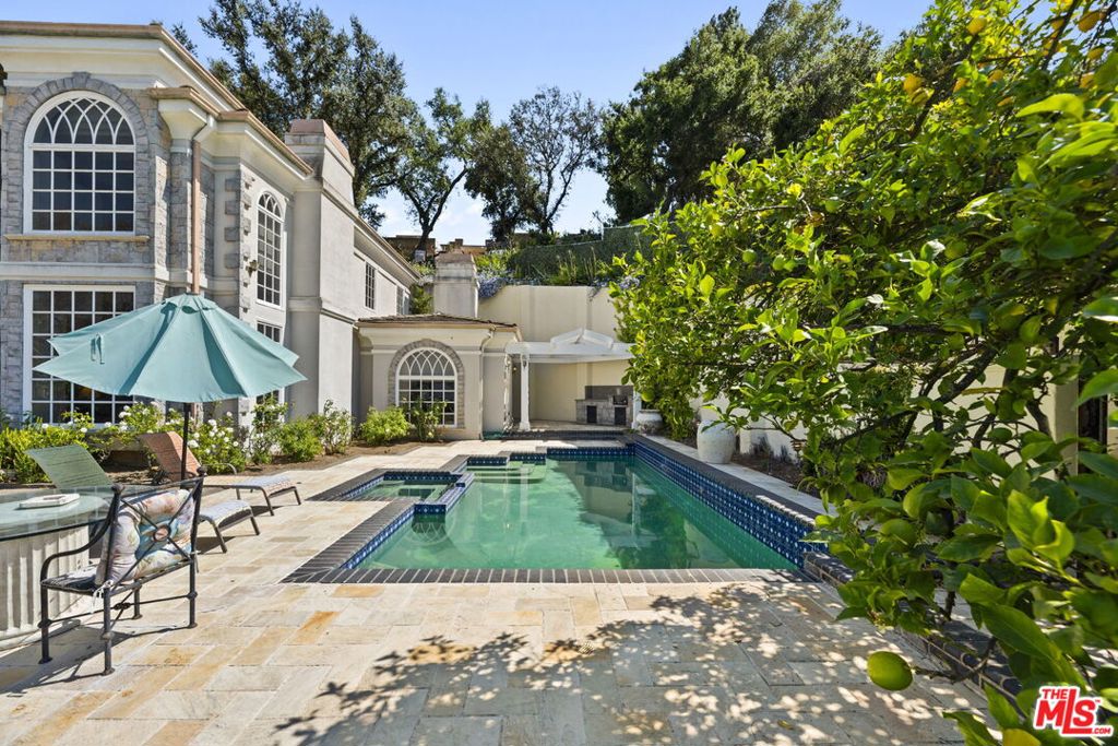 Perched on a private promontory above Mulholland Drive in prestigious Bel Air, this gated estate offers sweeping city and mountain views. Ideally located near elite private schools, the Beverly Glen Center, and providing effortless access to both the Westside and the Valley, downtown LA, and major studios, this home is the epitome of convenience and luxury.Thoughtfully designed, the spacious floor plan features 5 bedrooms and 5 bathrooms, including an extraordinary primary suite with oversized closets. Highlights include a dramatic two-story foyer, a gourmet chef's kitchen, a generous family room, a dedicated office, and refined finishes throughout.Perfect for both intimate gatherings and grand entertaining, the expansive outdoor space boasts a sparkling pool and lush, flat lawn set against the backdrop of panoramic vistas. This exceptional Bel Air retreat blends privacy, elegance, and location in one of Los Angeles' most coveted neighborhoods.