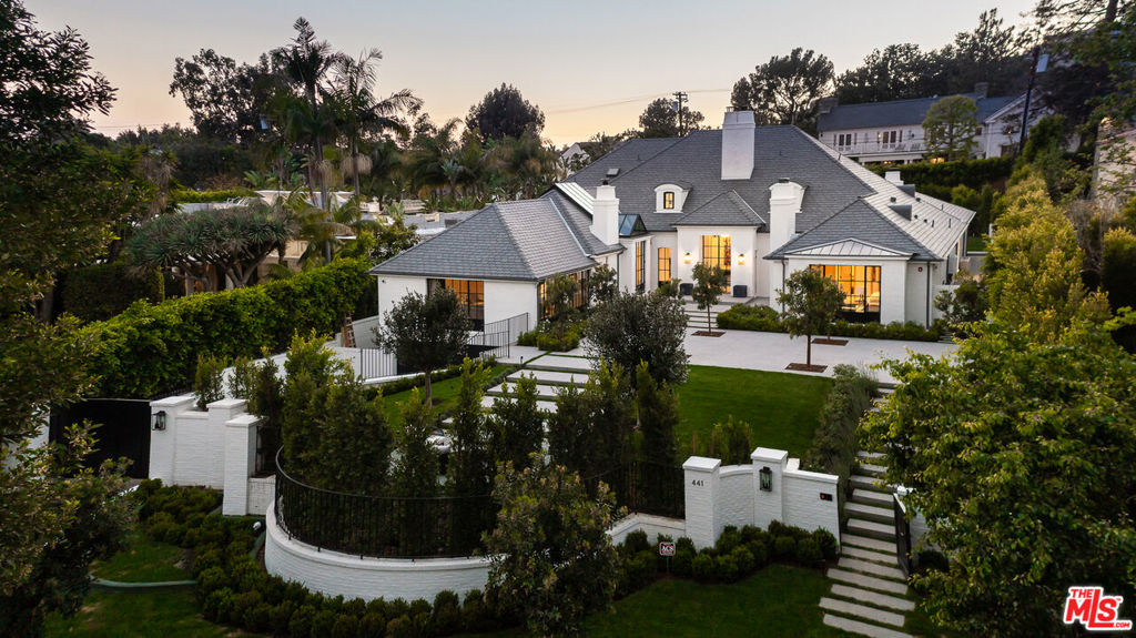 Pristine, stately and ideally positioned on a sprawling lot set high above the street, discover this exquisite traditional masterpiece in the exclusive Brentwood Park. With a very extensive custom renovation just completed, the North Bristol estate showcases cohesive design elements blending rustic textures and organic materials creating the perfect mix of both masculine and feminine energy. The blend of classic traditional and contemporary design evokes feelings of warmth while understated elegance remains constant. The three level home offers six bedrooms, including a stunning main floor primary suite with a spa bath and remarkable finished closet. The home has been designed to reflect today's on-trend style while honoring classic clean lines and with a modern flair. The black steel framed floor to ceiling windows and doors along with the striking glass pitched ceiling above the gourmet kitchen allow for maximum natural light throughout the house. Rich textures like French oak, brass, and soft white walls accent the home. The exterior grounds are equally captivating, featuring lush green landscape and a picturesque resort style pool. This property offers its owners the utmost privacy along with excellent space for entertaining for both intimate gatherings or grand scale events.