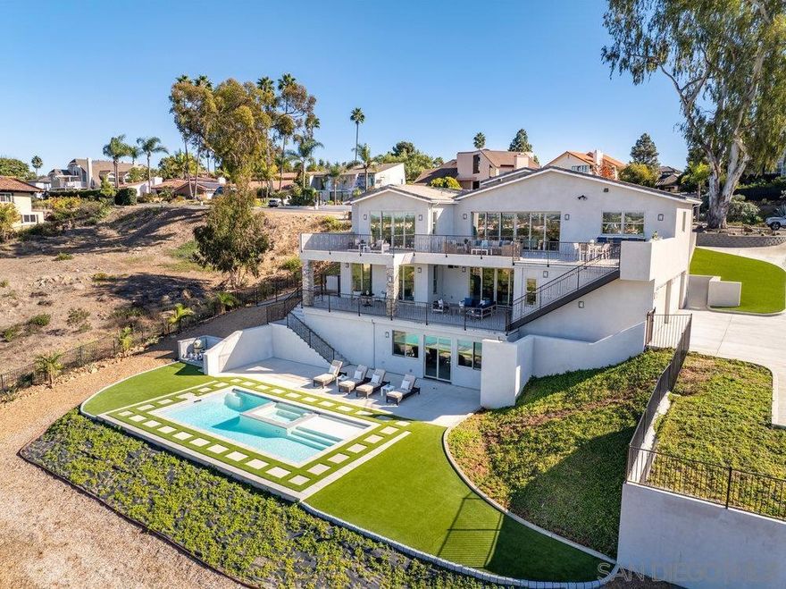 Situated on nearly 3/4 of an acre, this extraordinary residence boasts sweeping, unobstructed ocean and mountain views, creating a picturesque backdrop for luxury living. Located in the prestigious La Costa Meadows community, this newly constructed home is a masterpiece of design and craftsmanship, with every detail thoughtfully curated. Inside, enjoy engineered oak hardwood floors, stunning granite countertops, and high-end Décor appliances. The convenience of a private elevator seamlessly connects all levels, adding to the home’s exceptional functionality. The main-level primary suite serves as a peaceful retreat, while the lower levels host additional bedrooms and an expansive entertainment space, providing direct access to a newly added below-ground pool and jacuzzi. This outdoor oasis offers a private sanctuary for relaxation and gatherings. Don’t miss this rare opportunity to experience the pinnacle of California living in one of Southern California’s most desirable locations.