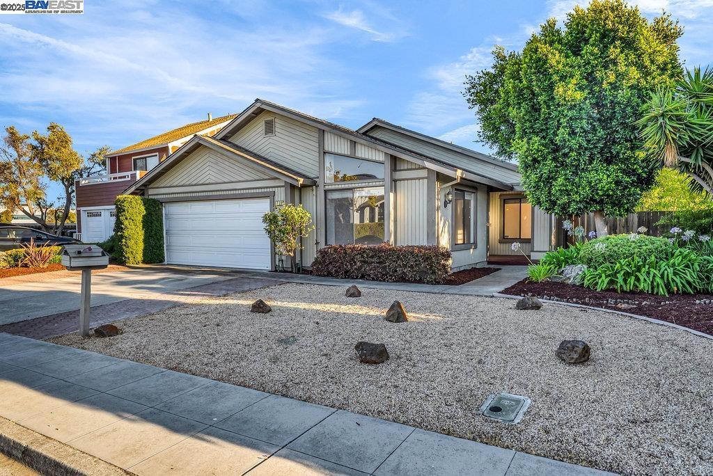 Nestled in the sought after Alden Park community, this well maintained home 3 bedroom, 2 bath house is situated on a premium 8,000+ sq ft corner lot with no rear neighbors! This well-designed floor plan offers a bright, living room with high sloped ceilings and abundant natural light. The kitchen boasts new tile flooring, some stainless steel appliances, and a convenient pantry, opening to a spacious family room with a gas fireplace and vaulted ceilings. The primary suite includes triple closets and sliding patio door conveniently leading to the backyard. The primary bath features a double vanity, split layout, a stall shower, and a separate tub. Additional highlights include new luxury vinyl flooring, fresh new interior paint, indoor laundry, central heating, and an attached 2-car garage with automatic opener. Enjoy the low-maintenance front and back yards, surrounded by mature trees, blooming plants, landscape rocks, and a variety of fruit trees. Fantastic location next to the Bay walking trail and close to Sea Cloud Park and Belmont Sports Complex. This house offers the perfect blend of natural beauty and urban convenience. A must-see!
