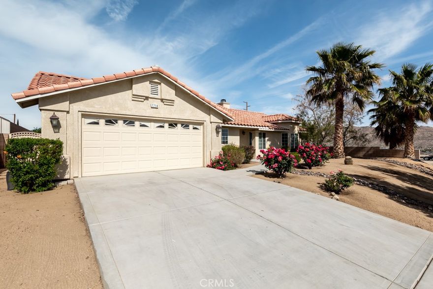 Beautiful Spanish-style home in one of Yucca Valley’s most desirable neighborhoods—La Paz. Built by renowned local builder Don Lander, this 3-bedroom, 2-bath residence combines timeless craftsmanship with modern comfort. The 1,561 sq ft floor plan features porcelain tile flooring, dual-pane windows, and a cozy wood-burning fireplace. The open-concept kitchen offers granite countertops, rich wood cabinetry, and stainless steel appliances, seamlessly connecting to the dining area for everyday living and entertaining. The spacious primary suite includes a walk-in closet, dual sinks, granite counters, and a soaking tub. Two additional bedrooms provide flexible space for guests or a home office. Enjoy outdoor living under the covered patio in a private backyard enclosed by a block wall, ready for your landscaping vision. Additional features include an indoor laundry room with storage cabinets, a finished two-car garage, natural gas utilities, and low-maintenance landscaping with irrigation. Located on a quiet street with sidewalks and underground utilities, near schools and town amenities—this well-crafted home offers comfort, quality, and convenience in a highly sought-after setting.