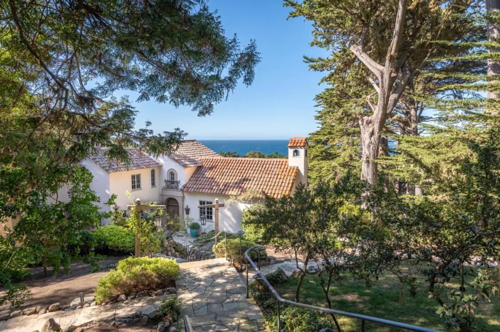 Situated on 3 acres of Monterey Cypress-studded land, sits this magnificent Spanish Revival, Carmel Highlands estate. The property boasts impressive open-ocean views of Point Lobos, coastal whitewater and the sunlight dappled natural beauty of Carmel. The 4,730 sq. ft. house was completely renovated in the early 2000s preserving the architectural details of a Spanish Revival home, while introducing the modern luxuries of today. Features include radiant floors, chefs kitchen with a La Cornue range, French limestone, and granite countertops, a Turkish spa highlighting a soaking jacuzzi tub, steam and waterfall shower, and large dry sauna. Upstairs, a private, primary haven awaits, including a cozy living area, executive office, and palatial bathroom, all with sweeping views of the Pacific. The lower lot is home to a large fire pit area, basketball court, and grass lawns to the gated Spindrift entrance, perfect to entertaining, hosting events, or just your private paradise by the sea.