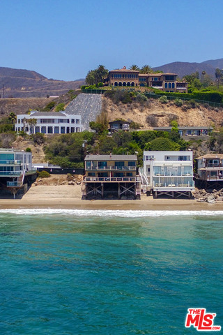 Triplex situated on 50 feet of prime Malibu Road Beachfront. An amazing penthouse spanning the whole upper level sits this decorators own 3 bedroom 2 bath showplace. The oceanfront great room includes gourmet kitchen, living room with fireplace and an incredible dinning area all leading to expansive out door decking to entertain and watch the whales and dolphins. The lower level includes two units that are both 2 bedrooms one with one bath one with 1.5 baths. They make for great rentals or guest suites. The property also has a 4 car garage and ample parking in front of garages or street parking. It is currently zoned as a 4 unit but is now 3 units. Great owner user while having rental income or perhaps turn the 4,032 SQ Ft(Per assessor) into a single family residence (subject to City of Malibu Approval) City of Malibu Septic Operating Permit on File.