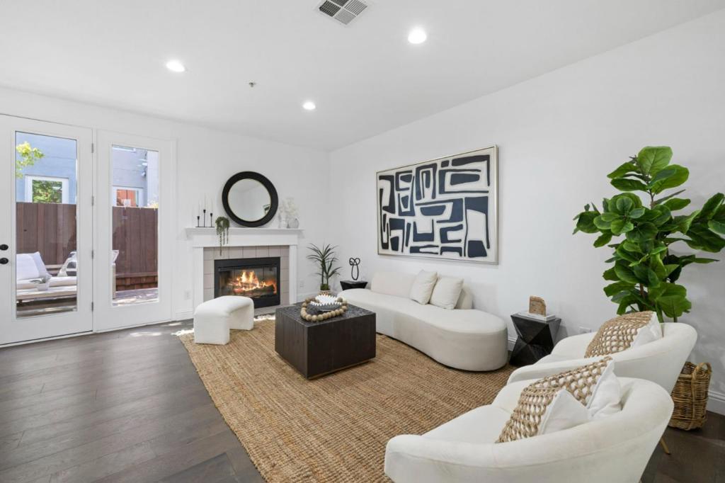 Welcome to this beautifully updated 2 bed, 1.5 bath two-story home, offering the perfect blend of style, function, and location. With no neighbors above or below, this feels more like a private retreat than a traditional townhouse. Step inside to discover new flooring, fresh paint throughout, and designer light fixtures that elevate every room. The spacious living room boasts a cozy wood-burning fireplace, and sliding doors that flood the space with natural light and open to a private outdoor oasis; perfect for morning coffee or al fresco dining. The updated kitchen features stainless steel appliances, freshly painted cabinetry, and a separate dining area ideal for hosting dinner parties or casual weeknight meals. Upstairs, you'll find the primary suite with vaulted ceilings and a full bath, while a second bedroom offers flexibility for guests, a home office, or family. Thoughtful storage includes large closets and a built-out area under the stairs. Whether you're commuting across the Bay or working remotely, this home offers the best of both comfort and convenience all tucked into a quiet, well-connected San Mateo community.
