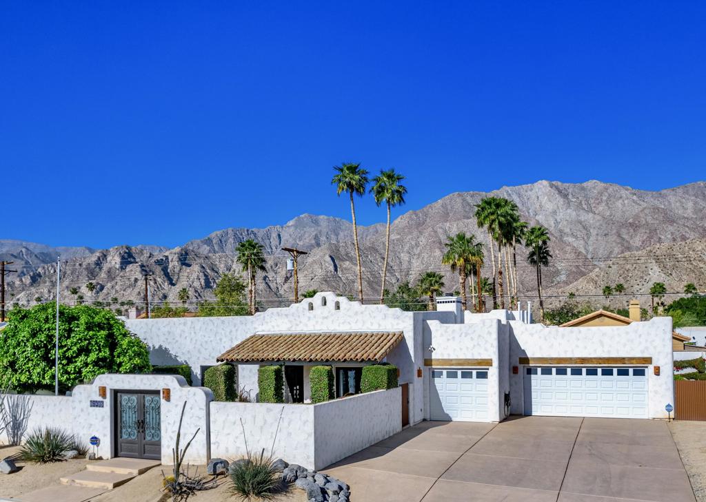 Welcome home to the Historic La Quinta Cove. This Santa Fe-style home embodies the Character and Charm of old La Quinta. Take a step back in time & escape to this unique home, a compliment to the original style of the ''Casita'' homes of the 1930's. This home has All the Coveted features & make it a Rare Find in the Cove: Premium ''Double Lot'', Enclosed Front Courtyard, Expansive Backyard w/mature fruit trees, Private Salt-Water Pool/ Spa, Mountain Views, Living space just under 2000 square feet, 4 Bedrooms/ 3 Bathrooms, 3 Car Garage, Large Driveway w/ RV parking. Private Front courtyard w/ wrought iron gate & wood details, offers additional outdoor space. Step inside a double door entry & you are welcomed to a warm, inviting open layout where creamy white walls combine w/ natural wood accents. Tile flooring w/ Spanish tile inlays create an earthy ambiance. Light a fire in the raised-hearth fireplace. Mountain views from dining area adjoining an updated kitchen. Large primary suite w/ direct access to pool w/ ensuite bath w/ dual vanities, walk-in closet, stall shower & soaking tub. 3 additional bedrooms offer ample space for family, friends & guests. Interior laundry room, 3 Car Garage w/ built in cabinets/shelving. Awaken your sense of adventure w/ Hiking/Biking trails outside your front door. Close proximity & within walking distance to Old Town La Quinta, Golf Courses, La Quinta Resort & Spa, Parks, Shopping/Dining. Easy access off I10 at Washington St.