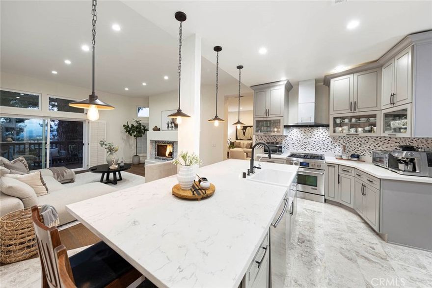 Experience resort-style luxury in this beautifully renovated home, perfectly situated within the prestigious guard-gated community in Newport Beach. Designed with a seamless blend of sophistication and comfort, the residence showcases quality craftsmanship, and thoughtful upgrades throughout.

A luminous entry welcomes you to an open floor plan with soaring ceilings and a skylight. The main level features a guest bedroom with full bath, formal living and dining rooms—both with elegant marble fireplaces—a spacious family room, and a versatile loft. French doors open to a view deck, ideal for indoor-outdoor entertaining. The gourmet kitchen is a chef’s dream with custom cabinetry, a quartz-topped island, breakfast bar, and premium stainless-steel appliances.

Upstairs, the primary suite offers vaulted ceilings, panoramic city-light and treetop views, a cozy sitting area with fireplace, a spa-inspired marble bath with freestanding tub, and a generous walk-in closet. Additional highlights include new wood and marble flooring, custom built-ins, quartz counters in all bathrooms, central air conditioning, and a three-car garage with epoxy flooring and long driveway for added parking.

Residents of Harbor Ridge enjoy four pools and spas, three tennis courts, 24-hour gate-guard security with patrol. The community is just minutes from world-class shopping and dining, top-rated schools, Pelican Hill Resort and Golf Course, and the most beautiful beaches in Orange County. This extraordinary home embodies the very best of coastal living in Newport Beach.