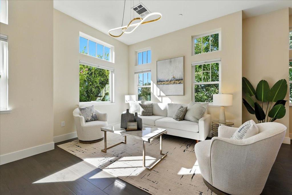 Welcome to this sun-filled corner unit modern townhome in Mountain View within the Los Altos High School District! Featuring 3 bedrooms, an office, 2.5 baths, and 1609 sqft of living space, this home offers a spacious layout with incredible natural light streaming through windows. The main floor showcases an open-concept design with a formal dining area and a sun-drenched living room. The gourmet kitchen is a chefs delight with a gas range, sleek cabinetry, SS appliances, and a large island ideal for cooking and entertaining. Upstairs, the luxurious primary suite features an en-suite bath with double sink vanity, a walk-in shower, and a spacious walk-in closet. A second en-suite bedroom offers perfect comfort for guests or family, while the third bedroom works as a kids room or office. 1st floor den is a flexible space for a home office or play area. Additional features include a two-car garage, engineered wood flooring, dual-zone A/C controlled by Nest, customized Hunter Douglas window blinds, and wool carpets .The community offers green spaces and BBQ area. Enjoy quick access to Magic Bridge Park, Safeway, Costco, major highways 101 & 85, LinkedIn, Meta Shuttle Station, and a walking trail to Google and shoreline park . Don't miss the chance to call this incredible home yours!