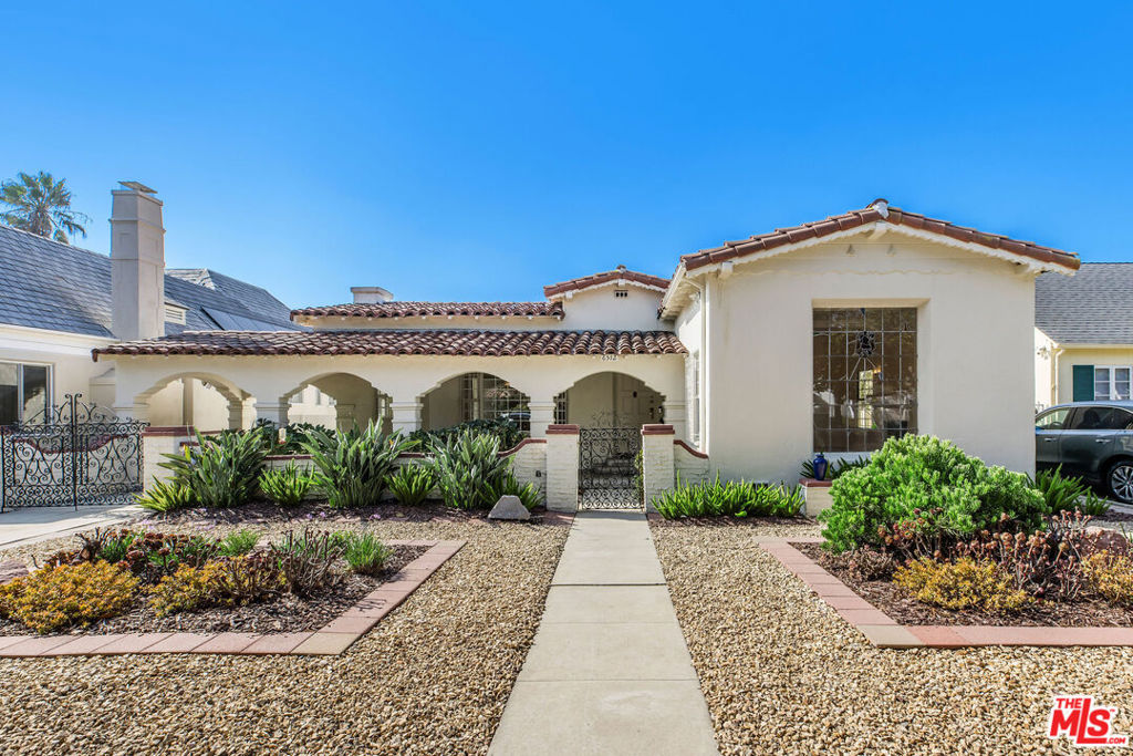This Spanish Colonial Revival home was commissioned by our client's grandmother in 1934. Here is an opportunity to secure a special home on a quiet, tree-lined street in the highly sought-after South Carthay historic district. This home is a 4-bedroom, 3-bath home offering over 2,600 square feet of thoughtfully designed living space on an expansive 8,552 square foot lot. There is classic architectural charm with arched doorways, period detailing, and a warm stucco exterior. The spacious layout includes a formal living room with a decorative fireplace, formal dining, and generously sized bedrooms. The large, private backyard is ideal for entertaining or relaxing, and is the perfect canvas to create the outdoor retreat of your dreams. Ideally situated close to Beverly Hills, The Grove, LACMA, and the new subway from Downtown to Century City.