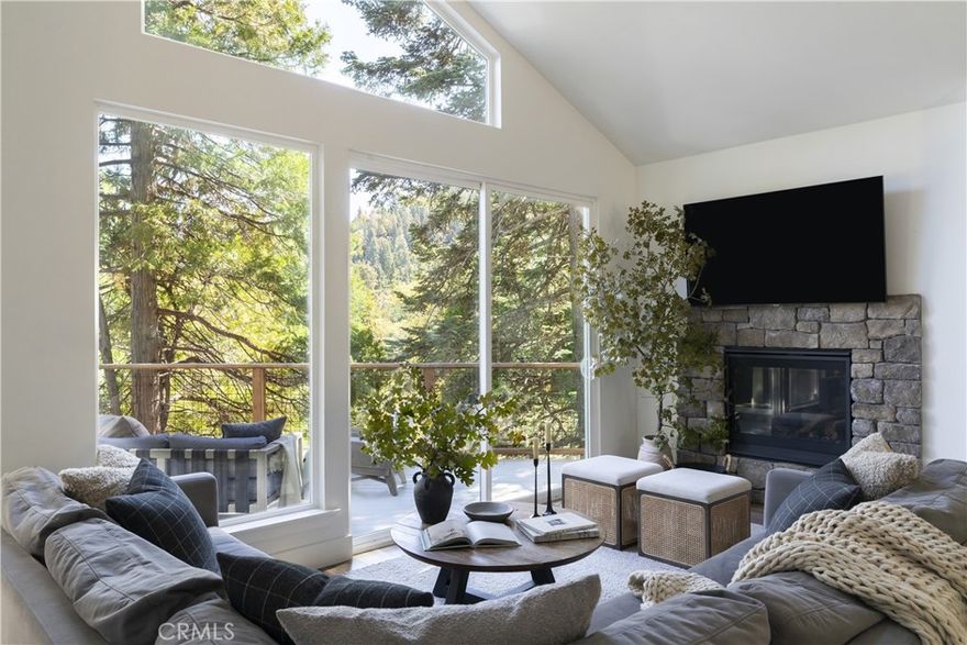 Meet Primrose Lodge! A luxury mountain getaway built in 2022 and designed with hosting in mind. Just two minutes from Lake Arrowhead Village and a short walk to the lake, this 6 bedroom, 5 bath home blends elevated comfort with laid back mountain living. One of the best parts? A level driveway, one car garage, and easy level entry straight into the main living space (no stairs needed). Inside, you’re welcomed by a spacious open layout with high end finishes throughout: quartz countertops, European style cabinetry, stainless steel appliances, a large kitchen island, and curated mountain inspired decor. The main level features a fully stocked gourmet kitchen, cozy living room with views of the pines, fireplace, dining area, expansive deck, and a primary suite. Downstairs offers just the right amount of extra space with a bonus living room, two guest bedrooms connected by a full bath, and another spacious deck with a fire pit, perfect for chilly mountain evenings. The bottom level includes an additional primary suite plus two more bedrooms with a shared full bath. All six bedrooms are thoughtfully furnished with comfort and ample closet space in mind. The bathrooms feature ceramic flooring, quartz countertops, high end fixtures, hardwood cabinetry, and luxury quality towels and toiletries. Primrose was made for entertaining, indoors and out. With two large decks, lounge seating, outdoor dining, fire pits, and a BBQ, it’s the ultimate mountain getaway. Other key highlights include two A/C units covering all three levels, dual laundry rooms, an EV charger, and parking for up to four vehicles. With lake rights, a strong rental history, an easy walk to the Village and lake, and being sold fully furnished, Primrose is ready for its next chapter. Whether that's a weekend getaway, full time escape, or income producing investment.