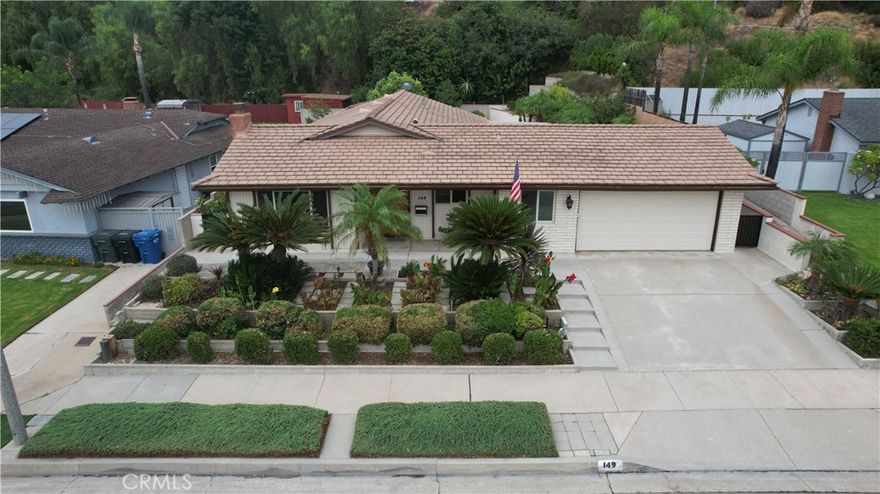 A Truly Lovely Home in The Grand Community of Glendora. Four (4) Bedrooms, Two Full Baths. Large Living Room with Fireplace. The kitchen has Quartz countertops. Lots of Cabinets and Storage Space. Formal Dining Room Adjacent to the Kitchen. The Floors in the Living Room, Dining Room, and Halls are New Wood Grain Vinyl Laminate. New Carpet in the Bedrooms, and Tile in the Kitchen and Baths. Huge Indoor Laundry Room With an Abundance of Cabinets and Storage. The Lot is Huge, 10,331 SQ-FT. The Front Yard is Beautifully Landscaped with an automatic sprinkler system. The Back Yard is a Refuge, Tranquil, with Many Fruit Trees and a sprinkler system too. Large tool shed at the rear of the backyard. South-facing home. The Covered Patio with 3 Ceiling Fans is Huge. Windows are Double Paned throughout. The Roof is Tile. The large two-car garage has Front and Rear Roll-up doors, Drive Straight through to the Back Yard. Also, Overhead Storage. Note, The Slab and Foundation Rear of the Master Bedroom is up to Code, Ideal for Expanding or Additional Rooms.