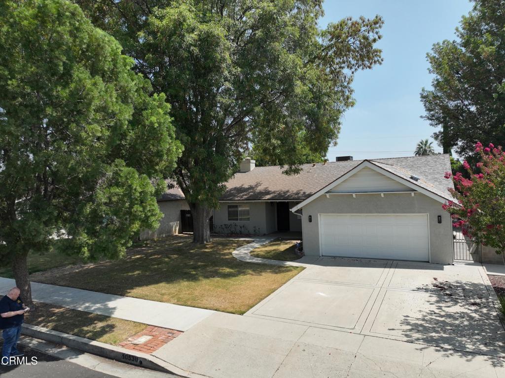 Located in the highly sought-after neighborhood of South Granada Hills, this spacious 4-bedroom, 2-bathroom home seamlessly blends modern upgrades with comfortable living. Step inside to an open-concept floor plan featuring glossy oversized tile flooring, recessed lighting, and a beautifully updated kitchen equipped with rich wood cabinetry, a sleek glass tile backsplash, stainless steel appliances, and a large center island perfect for entertaining. The expansive living and dining area flows effortlessly to the backyard through sliding glass doors that lead to a covered patio with views of a serene fountain centerpiece and a built-in outdoor barbecue area--ideal for alfresco dining.The home offers four generously sized bedrooms, including one with a bold accent wall and ceiling fan, and two well-appointed bathrooms--one with a modern walk-in shower and vessel sink, and the other with classic tiled finishes and ample storage. Additional highlights include dual-pane windows with plantation shutters, central HVAC, and a two-car attached garage. With charming curb appeal shaded by a mature tree and a backyard designed for gatherings, this move-in-ready property is a fantastic opportunity to enjoy peaceful suburban living with easy access to top-rated schools, parks, and freeways.