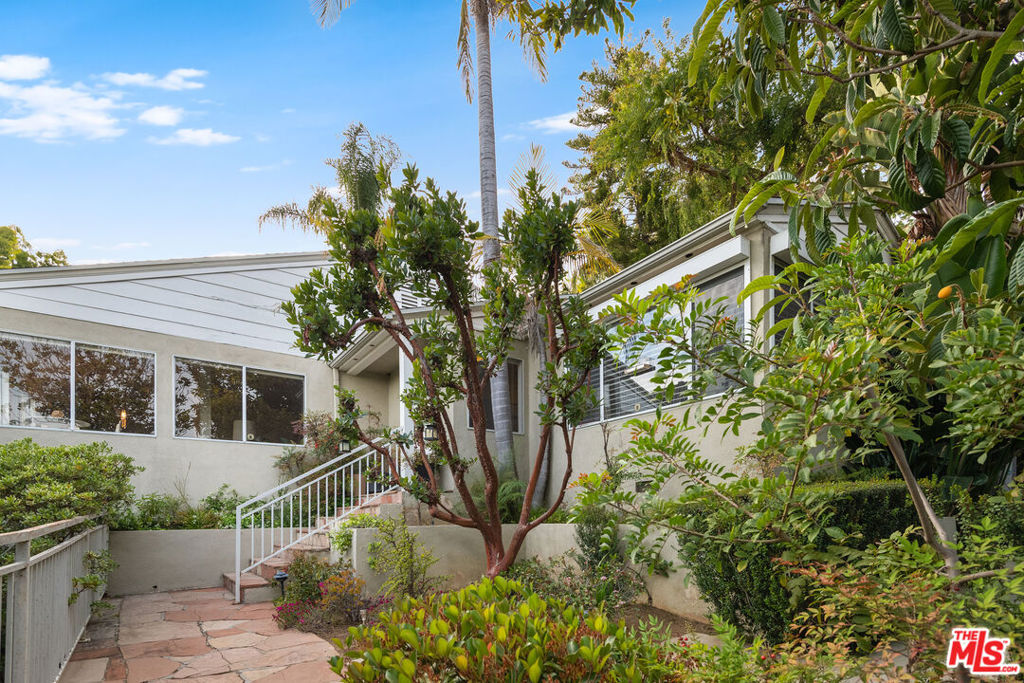 BEST LOCATION: North of Sunset, one story main house built 1948, high ceiling living room, 2 bedroom , 2 bath with an additional 2 story guest house built above a 2 car garage. Exceptional courtyard. Great views of the city super private.