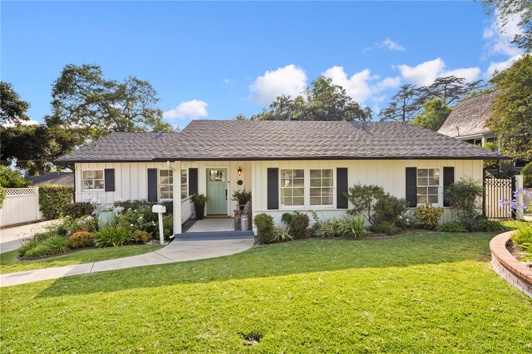 This beautifully maintained traditional ranch home is nestled in one of North Monrovia’s most desirable neighborhoods. This 3-bedroom, 2-bathroom home offers timeless curb appeal, original character, and thoughtful updates throughout. Step onto the inviting covered front porch, where a tranquil water fountain and lush professional landscaping set the tone for this special property. Inside, you'll find gleaming original hardwood floors, recessed lighting, and a spacious layout perfect for both everyday living and entertaining. The elegant living room features a cozy fireplace and flows seamlessly into a formal dining area. The kitchen has been tastefully updated with granite countertops, a chic tile backsplash, and stainless-steel appliances. A nearby three-quarter bathroom and dedicated laundry area with washer and dryer add functionality. A step-down family room is a true highlight, with a stunning wall of windows that frames the picturesque backyard and brings in an abundance of natural light. Custom built-ins add warmth and practicality to this inviting space. The home features two spacious guest bedrooms and a beautifully renovated full bathroom, complete with marble countertops, a designer tile tub and shower, and ample linen storage. The primary bedroom is privately situated at the rear of the home, offering peace and quiet. Outdoors, you’ll find a private, gated oasis complete with majestic oak trees, custom brick-lined patio, a built-in BBQ island with cooktop and countertop bar—perfect for dining and entertaining. Additional features include a tankless water heater, an updated electrical panel, a two-car detached garage, and a wide driveway with ample parking. Don't miss your opportunity to own this quintessential Monrovia gem where comfort, character, and style come together in perfect harmony.