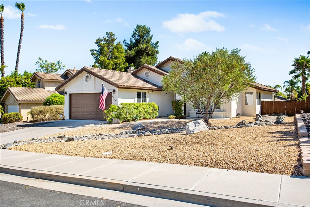 Step into the comfort and ease of single-story living at 40336 Crystal Aire Drive, where open space, thoughtful upgrades, and a flowing layout create a warm, welcoming home. Set on a spacious 7,405 sq ft lot, this 3-bedroom, 2-bath home offers 1,428 sq ft of light-filled living space designed for both relaxation and function.
As you enter, you're greeted by updated flooring that flows seamlessly throughout the whole home, drawing you into the heart of the home. The open-concept living and dining space is anchored by a striking two-sided fireplace, one side warming the living room, the other enhancing the charm of the adjoining dining area. With vaulted ceilings overhead and natural light pouring through large windows, the space feels both expansive and inviting.
The kitchen offers a clean and efficient layout with plenty of cabinet storage, generous counter space, and a breakfast nook that overlooks the backyard. Whether you're preparing a weekday meal or entertaining on weekends, this space is ready to meet your needs.
Down the hall, you'll find three comfortable bedrooms, including a spacious primary suite with private bath access and ample closet space. The secondary bedrooms are well-sized and share an updated hall bathroom with modern finishes.
Outside, a large covered patio invites morning coffee, evening dinners, or peaceful lounging in the shade. The backyard is a blank canvas of green grass, easy to maintain or ready for your vision if you’d like to add garden beds, a play area, or additional outdoor living space.
Additional features include an attached two-car garage, indoor laundry area, and newer fixtures throughout. The location offers peaceful residential streets with the added bonus of being just a short walk to a nearby park complete with a grass field and playground.
40336 Crystal Aire Drive delivers the best of easy living, clean, open, and move-in ready with room to personalize. Don’t miss this opportunity to own a beautifully maintained home in the heart of Murrieta.