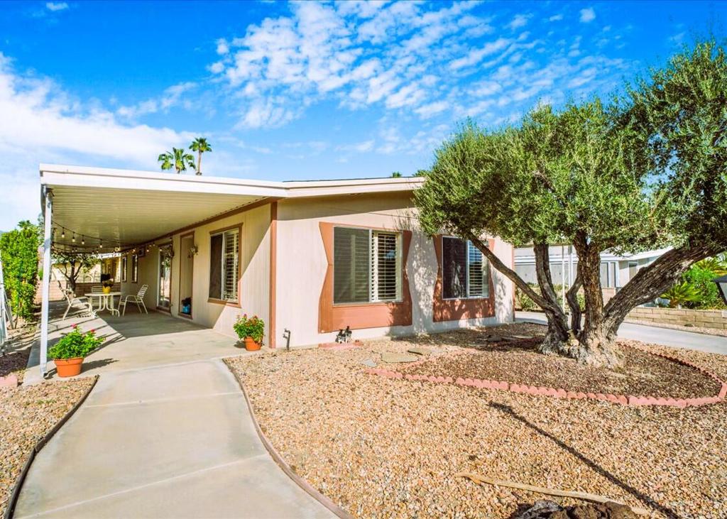 Checks All The Boxes! :55+Gated Golf Course Community-Great Price!-Move-in-Ready!:Low HOA Fee!-Walk to Remodeled Clubhouse!-Pickleball,Bocce,Pub,Cards,& 3 pools! This lovely 2Br,family room home is light & welcoming with a great Cul-de-sac location near the Clubhouse in Portola Country Club where you own your land. Enjoy the new 4-ton Central Air Conditioner & furnace that cools like a dream and is quiet as well. The living-room & formal dining area have plantation shutters. The kitchen has a built-in dining island looking toward the family room & outdoor patio area. Nice white gas appliances, double sink & light oak laminate flooring for easy care. The family room has a wet bar, track lighting & built in bookshelves. The extra large office/laundry room has plenty of storage & built in desk for your computer & printer. The primary BR features an ensuite bath with separate shower & soaking tub & vanity with dual sinks. The guest bath adjacent to the guestroom has a vinyl shower with built-in seating. Dine ''Alfresco'' in your covered patio enclosed with slumpstone wall & Fiscus trees for privacy. The area can also be a perfect play area for your canine pal with the addition of a gate. The entire home is enclosed on three sides with nice slumpstone and there is parking for two cars & a golf cart under the covered carport that has entry access direct into the kitchen. A large storage shed gives you room for your bikes, garden tools, etc. Portola Country Club has only 500 homes ranging from the mid-200's to $500,000. Come take a look at this great opportunity to live in such an exceptional 55+community in Palm Desert.