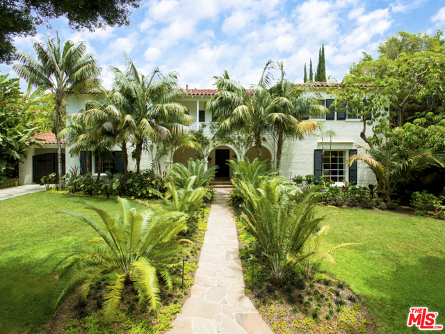 This spectacular 1930 Paul Williams 6-bedroom home in the coveted Beverly Hills flats has been beautifully preserved and updated to offer contemporary elegance and luxurious details. The finest materials and finishes were used in restoring this timeless Monterey Colonial residence. The ground level space features formal living and dining; gourmet chef's kitchen with ample family space and welcoming breakfast nook; library; wine cellar; and housekeeper suite. Upstairs holds four generous en suite bedrooms, den and a sweeping master suite with dual walk-in closets and bathrooms. A classic wrap-around terrace drenched in roses overlooks the grounds. The generous and lushly landscaped one-third acre lot invites easy indoor-outdoor dining and entertaining around the pool, outdoor fireplace, cabana and dining area with barbecue and pizza oven. A detached guest apartment above the three-car garage boasts a spacious one-bedroom retreat with living room and bath.