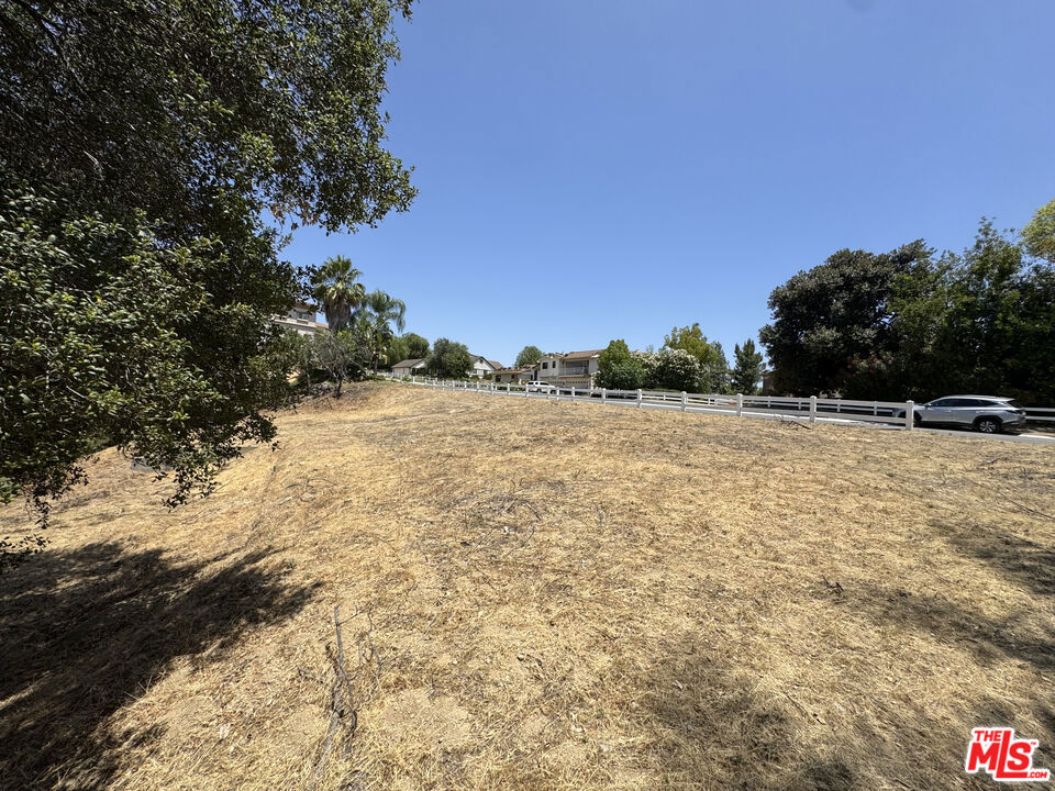 Welcome to 22455 Ridgeline Road, an extraordinary opportunity to acquire a prime parcel of vacant land in the heart of The Country Estates, one of Diamond Bar's most coveted neighborhoods. This rare offering invites discerning buyers, developers, or custom homebuilders to create a private legacy estate on a spacious and buildable lot surrounded by nature in a quiet and friendly neighborhood. Situated behind 24/7 guard-gated access, this oversized lot features a gently sloping large building pad ideal for designing and building a substantial custom home. The parcel sits on an elevated section of Ridgeline Road and enjoys sweeping views of the city and rolling hills below, providing an architectural view backdrop along with peace and privacy. The peaks of Mount Baldy are also visible in the distance. The Country Estates is known for its quiet, park-like setting, and estate homes on expansive lots. Residents enjoy exclusive access to a host of premium amenities including a private community pool, tennis courts, clubhouse, playground, and security patrol. With well-maintained roads, mature landscaping, and guard gated access, this neighborhood is a true retreat in the heart of Southern California. This location offers the perfect blend of privacy and convenience just minutes from award-winning schools, shopping centers, golf courses, and major freeways connecting you to Los Angeles, Orange County, and beyond. An incredible opportunity in one of Diamond Bar's most coveted enclaves. Buyer to verify utility access, plans and permits, and neighborhood architectural rules and restrictions.