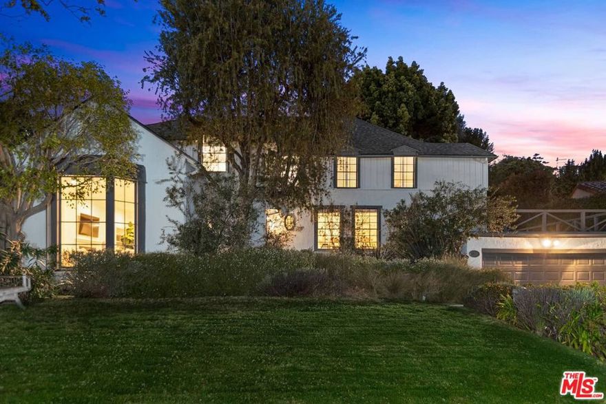 Sited gracefully on an unusually expansive, one-third acre parcel in the heart of Westwood's prime Little Holmby, this substantial home has been updated tastefully and with sensitivity to and respect for its architectural roots. Built masterfully in 1936, its evocative period details remain lovingly cared for, intact and gleaming...wood floors, crown moldings and more. With five bedrooms, there is plenty of room for everyone and its fabulous, nearly 1000 square-foot Guest House adds a compound-like feel and function to this very special property. The stately entry foyer opens to the elegant formal living room, warmed by a romantic fireplace, and brightened by its big bay window taking in the glorious front yard and neighborhood views. The formal dining room with its charming wainscoting also has front-yard vistas and opens to the well-appointed, updated kitchen complete with a spacious eating area and easy access to the adjacent family room and to the backyard. The family room is large yet is very cozy in feel and has plenty of room for relaxing in front of the TV. A fifth bedroom and bath, a chic powder room, and a laundry room complete the first level.  All four upstairs bedrooms are roomy and bright, the terrific primary suite complete with vaulted ceilings and a fabulous newer, spa-like bathroom. There's a huge glass-enclosed shower and a separate, sumptuous tub. The three secondary bedrooms are all adjacent to the primary and are lovely. The backyard is quite extensive and built for grand entertaining. Serve casual meals and cocktails to guests on the sunny back patio through both French doors and a massive, wide-open pass-through kitchen window. Kids can play easily and supervised on the nearby grassy yard space. Up a few steps to the second tier of the yard, find an enormous, hotel-like swimmer's pool surrounded by more play space and many areas perfect for alfresco lounging and sunning. Graciously open to the pool area is the very welcoming and functional guest house outfitted with a fireplace, a bath, a dry sauna and a kitchenette. There is significant storage throughout. Also, it is situated in the coveted Warner Avenue Elementary School District and located in close proximity to UCLA and to the fine shopping and dining in nearby Westwood, Century City and Beverly Hills.