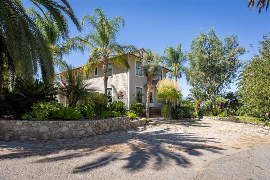Built in 1911, this ONE OF A KIND quaint Pool home sits on over 2.0 acres.  Beautiful layout, with 2 additional Gazebos and a backyard area that is great for entertaining.  Home sits behind electric gates, with a long driveway to enter its stunning mountain views.  Possibilities are endless with the additional APN of land.  Features 4 bedrooms, 2 bath, Pool, Spa, Bonus Room, Den and Wine Cellar.  This home has countless palm trees and orange groves.  Come experience the tranquility of this property at 628 Sunnyside