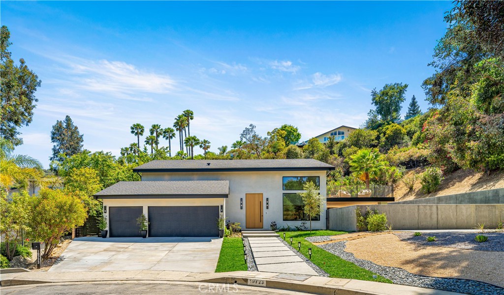 At the end of a quiet cul-de-sac in one of Tarzana’s most coveted neighborhoods, discover this newly remodeled, one-of-a-kind sanctuary that seamlessly blends luxury, comfort, and indoor-outdoor living. Designed for those who value peace, privacy, and impeccable style, this home is a rare find that delivers on every front. With 5 bedrooms—3 of them en-suite, including one conveniently located on the main level—4.5 beautifully appointed bathrooms, and two laundry rooms (one upstairs, one downstairs), this home offers a highly versatile layout ideal for families, multigenerational living, or effortless entertaining. Additional highlights include a den with a custom wet bar, a 3-car garage, and multiple outdoor living areas—complete with a sparkling pool, spa, expansive private balcony, and a fully equipped outdoor BBQ and bar—designed to deliver the ultimate California lifestyle.
At the heart of the home is a show stopping chef’s kitchen that anchors the open-concept living space. Centered around a dramatic 13.5-foot marble island, the kitchen features a built-in coffee bar, custom oak cabinetry, and top-of-the-line appliances and fixtures—offering both style and substance for everyday living or hosting unforgettable gatherings. Upstairs, retreat to the luxurious primary suite—your personal escape—featuring a spa-inspired bathroom with a custom wet room, elegant designer finishes, a custom walk-in closet, and a private expansive balcony with tranquil treetop views. Oversized sliding doors open to a spectacular, sprawling patio, creating seamless indoor-outdoor flow and transforming the space into a year-round retreat. Whether dining al fresco, lounging by the pool, or entertaining under the covered patio, every outdoor area is thoughtfully designed to expand and enhance your lifestyle. Bonus: A generous concrete pad at the side of the home offers endless potential—perfect for a sport court, ADU, studio, or whatever your vision may be. This exceptional property is the perfect fusion of modern luxury and thoughtful design—all in a location that feels like a peaceful retreat, yet remains just moments from everything. Welcome home!