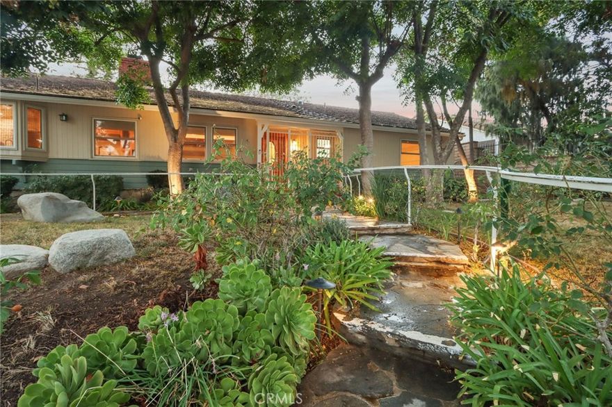 Charming Ranch-Style Retreat in the Heart of Old Granada Hills.  Nestled in a picturesque Granada Hills neighborhood, this beautifully maintained single-story ranch home offers timeless character, thoughtful updates, and incredible potential. Situated on an expansive 14,997 sq ft lot, this 4-bedroom, 4-bath home spans 2,271 sq ft of inviting living space—perfect for entertaining, relaxing, or expanding your vision.  Step inside to discover a light-filled kitchen adorned with granite countertops, travertine backsplash, stainless steel appliances, a built-in refrigerator, and a charming bay window. The spacious eat-in area flows effortlessly into a formal dining room, ideal for hosting family and friends.  The warm and inviting living room is the heart of the home, featuring stunning wood-beamed ceilings, a classic marble fireplace, and elegant French doors that open to your private backyard escape. With four generously sized bedrooms, including two en suites, there’s room for everyone to unwind. The primary suite is a true sanctuary with a walk-in closet, French doors to the backyard, and a luxurious bath complete with a soaking tub and separate shower.  A dedicated indoor laundry room adds modern convenience, while original details and tasteful upgrades preserve the home’s unique charm.  Outside, the possibilities are endless. Entertain year-round under the expansive 660 sq ft L-shaped covered patio, enjoy cozy evenings around the gas firepit, or soak in the rock spa under the stars. The huge backyard is a blank canvas—whether you envision lush gardens, a pool, or a playground, there’s space for it all.  Looking for more flexibility? The detached two-car garage, complete with an additional storage room or den, offers fantastic ADU or guesthouse potential. Located in the highly sought-after Granada Hills Charter High School district and just moments from the beloved Granada Hills Farmers Market, shops, and dining, this home combines comfort, character, and convenience in one incredible package.  Don’t miss the opportunity to create your dream lifestyle in this one-of-a-kind Granada Hills gem!