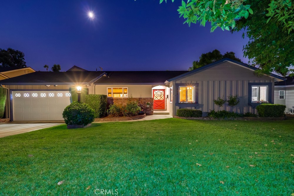 Welcome to 522 E Carroll Avenue, a beautifully maintained Glendora home combining spacious living with modern comfort and charm. The exterior features manicured landscaping and a clean lawn, leading to a welcoming front patio and striking red front door, enhanced with a security system for peace of mind.
Step inside to rich dark wood floors and an inviting layout. To the left, the kitchen is a true centerpiece, featuring dark wood cabinetry, a massive island, abundant storage, multiple matching light fixtures, and recessed lighting. Light countertops complement the cabinetry, and an open passage connects the kitchen to the formal dining area, seamlessly linking the heart of the home with the living spaces.
The main living room boasts a large stone fireplace and a second dining area, each defined by its own ceiling fan, creating distinct zones for entertaining and relaxation. A bonus room, separated by an arched opening and carpeted for comfort, offers flexible space for a home office, playroom, or media room, and provides direct access to the backyard. Another fireplace anchors the front living area, further enhancing the home’s cozy yet elegant ambiance.
A hallway off the front entry leads to two generously sized bedrooms with ceiling fans and ample closet space, plus a full bathroom. The primary suite features its own ensuite bathroom, closet space, and ceiling fan, offering a serene retreat within the home.
Outside, the backyard is an entertainer’s paradise. Sliding glass doors from both the dining room and bonus room open to a large space with a shaded seating area, concrete paths around a sparkling pool and jacuzzi, a lush grass section, and additional landscaping that provides privacy and beauty.
With a thoughtful layout, multiple fireplaces, and a perfect blend of indoor and outdoor living, 522 E Carroll Avenue offers a comfortable, stylish, and inviting home in the heart of Glendora.