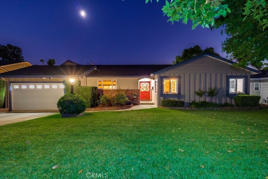 Welcome to 522 E Carroll Avenue, a beautifully maintained Glendora home combining spacious living with modern comfort and charm. The exterior features manicured landscaping and a clean lawn, leading to a welcoming front patio and striking red front door, enhanced with a security system for peace of mind.

Step inside to rich dark wood floors and an inviting layout. To the left, the kitchen is a true centerpiece, featuring dark wood cabinetry, a massive island, abundant storage, multiple matching light fixtures, and recessed lighting. Light countertops complement the cabinetry, and an open passage connects the kitchen to the formal dining area, seamlessly linking the heart of the home with the living spaces.

The main living room boasts a large stone fireplace and a second dining area, each defined by its own ceiling fan, creating distinct zones for entertaining and relaxation. A bonus room, separated by an arched opening and carpeted for comfort, offers flexible space for a home office, playroom, or media room, and provides direct access to the backyard. Another fireplace anchors the front living area, further enhancing the home’s cozy yet elegant ambiance.

A hallway off the front entry leads to two generously sized bedrooms with ceiling fans and ample closet space, plus a full bathroom. The primary suite features its own ensuite bathroom, closet space, and ceiling fan, offering a serene retreat within the home.

Outside, the backyard is an entertainer’s paradise. Sliding glass doors from both the dining room and bonus room open to a large space with a shaded seating area, concrete paths around a sparkling pool and jacuzzi, a lush grass section, and additional landscaping that provides privacy and beauty.

With a thoughtful layout, multiple fireplaces, and a perfect blend of indoor and outdoor living, 522 E Carroll Avenue offers a comfortable, stylish, and inviting home in the heart of Glendora.