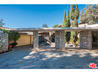 Once in a lifetime chance to own this piece of Hollywood History! Gated 2.9 acre 10+car private driveway. The Charlton Heston Estate features mountain views from almost every room. The master suite is complimented by separate dual baths and walk-in closets, fireplace, office and one of-a-kind 2-story library with outstanding views. Open living area for entertaining, private office with balcony, formal dining with Terrazzo floors, marble stone bar, 2 additional en suites and maids quarters in the main house. Outdoor features built-in BBQ, pool, Tennis Court and serene meditation area. Alongside the TC sits a Tennis Pavilion featuring a 2-story observation deck, a 3-story art studio with soaring ceilings and elevator, a screening room and an additional bedroom with bath and private entrance.