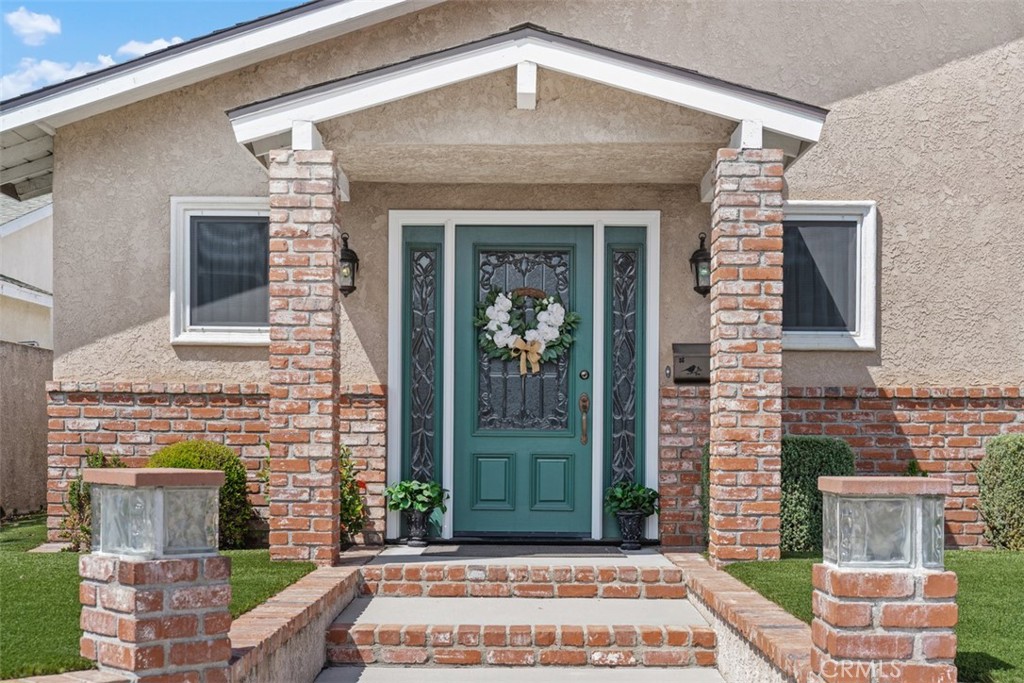 Beautifully maintained home with approx. 1,765 sq. ft. living space, backing to the Navy Golf Course. Step inside to a spacious living room with can lighting, coffered ceiling, fireplace, custom cabinetry, and a built-in bar. The remodeled kitchen features stone countertops, a custom island, and large windows overlooking the yard, flowing into the family area for easy entertaining. The expanded master suite includes a large walk-in closet, updated bathroom, and patio door to the private yard. Additional highlights include dual-pane windows, copper repipe, forced air heating, central air conditioning, ceiling fans, and soft water system. The finished two-car garage includes custom cabinetry, attic storage, and a laundry area with sink. Outdoor living features a covered patio, artificial turf, low-maintenance landscaping, and spa with custom gazebo. Conveniently located near the 405, 605, and 22 freeways, with nearby shopping (including Costco, Trader Joe's), parks, and award-winning schools: Patton Elementary, Bell Intermediate, and Pacifica High School.
