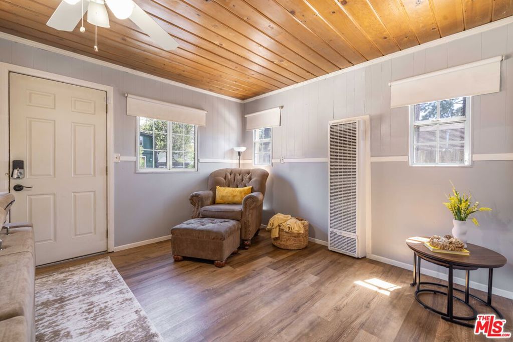 PRICE TO SELL! " Come enjoy the mountains of Big Bear! Centrally located and within walking distance to the community market and hiking trail systems, this idyllic cabin is just 14 minutes from the village, 10 minutes from the lake or ski resorts, and 6 minutes from grocery stores. This property is one bedroom fitting three beds, tucked away in a peaceful neighborhood. This cabin comes loaded with amenities and includes a washer/dryer, refrigerator, coffee machine, microwave and all the cabin furniture. Upon entering, you will find a family room, kitchen and dining area. In addition, the cabin is flanked with T&G ceilings and a natural rock fireplace with an open layout and has thermostat controlled heating and window A/C. On the second floor, you will find a spacious bedroom that accommodates two beds, This cabin is fully fenced with a dual side gate for an RV or private boat and also includes an outdoor shed for a workshop or extra storage. There is ample space to build an ADU on the grounds if desired. This property in a 5,000 sqft lot, offering a versatile opportunity is as a primary residence, vacation home, or rental investment. FREE 1 YEAR HOME WARRANTY. AB38 property Inspection is in compliance by fire dept.
