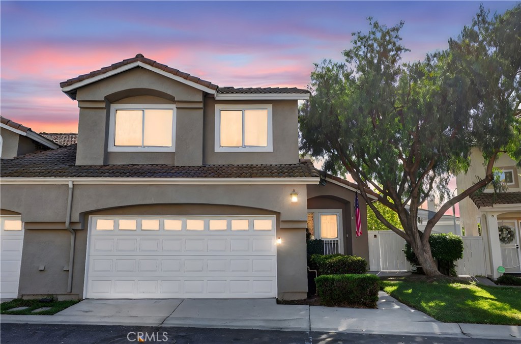 Step into this bright and well-designed townhouse in the desirable Corona Hills area. Vaulted ceilings greet you on the main floor, where the living room with a cozy gas fireplace and half bath opens onto a covered patio and small yard with no rear neighbors—ideal for outdoor lounging or casual dining.  The updated kitchen features full-sized, stainless steel appliances, and flows into the dining nook for seamless entertaining.  Upstairs you’ll find three bedrooms and two full bathrooms—one of which is the primary suite with dual sinks and step-in shower.  A direct-access two-car garage gives you parking and storage convenience.  The association pool and spa are just steps away, giving you resort-style relaxation right in your community.  Location is a win: close to shopping, dining and major freeways (91 / 15) for easy commutes and convenience.