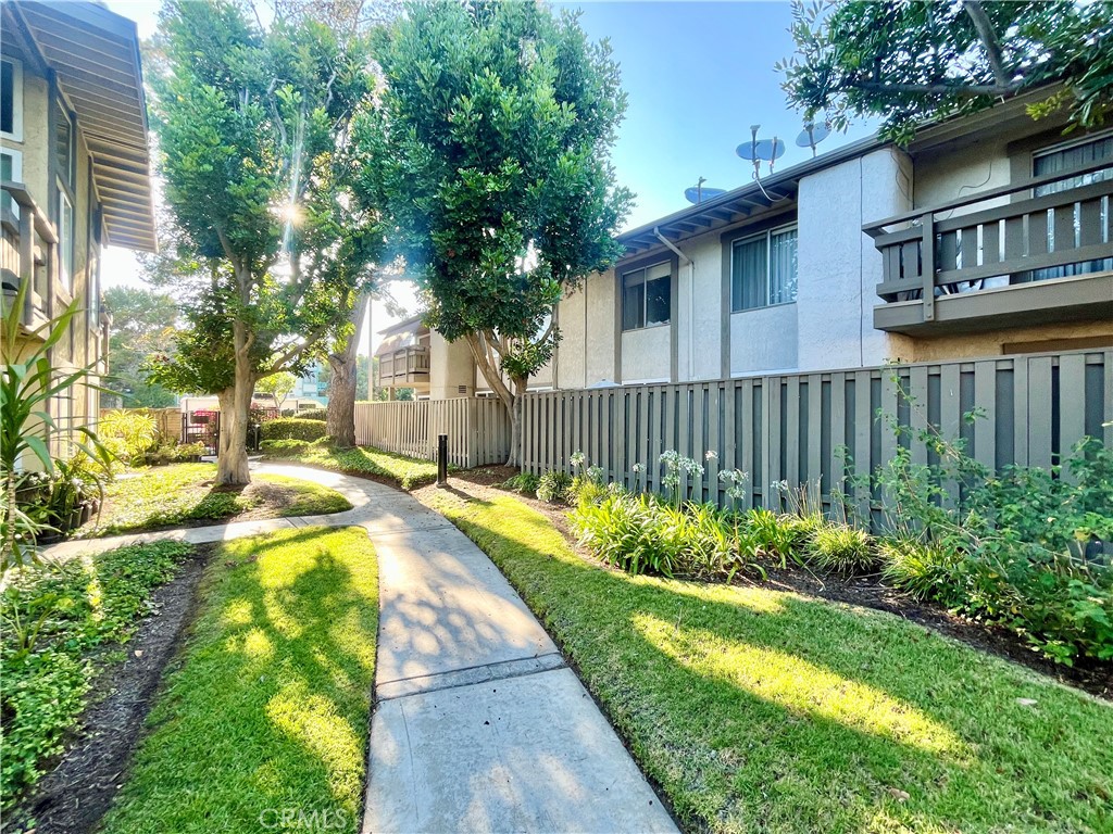 Tucked away in the peaceful, tree-lined Ponderosa Pines community, this ground-floor corner condo blends privacy, comfort, and modern charm. Surrounded by lush lawns and meandering walking paths, the home offers a quiet retreat with a contemporary feel.
Enter through a secure gated entrance into a light-filled, open-concept layout perfect for easy living. The updated kitchen features warm tan shaker cabinetry, granite countertops, and included appliances, while a cozy dining nook invites you to enjoy casual meals or your morning coffee.
Just off the living room, sliding glass doors lead to a spacious private patio—partially covered and part open-air—ideal for relaxing, dining alfresco, or entertaining friends.
The primary suite boasts a modern ensuite bath with rich brown tile and a tub-shower combo. The second bathroom features a sleek walk-in glass shower. Thoughtful touches like ample hallway storage, roomy closets, and two assigned parking spaces make everyday life even more convenient.
Enjoy resort-style amenities including a community pool, hot tub, and on-site laundry—all just steps from your front door. With easy access to LAX, SoFi Stadium, major freeways, and a vibrant mix of shopping and dining, this home truly offers the best of comfort, style, and location.