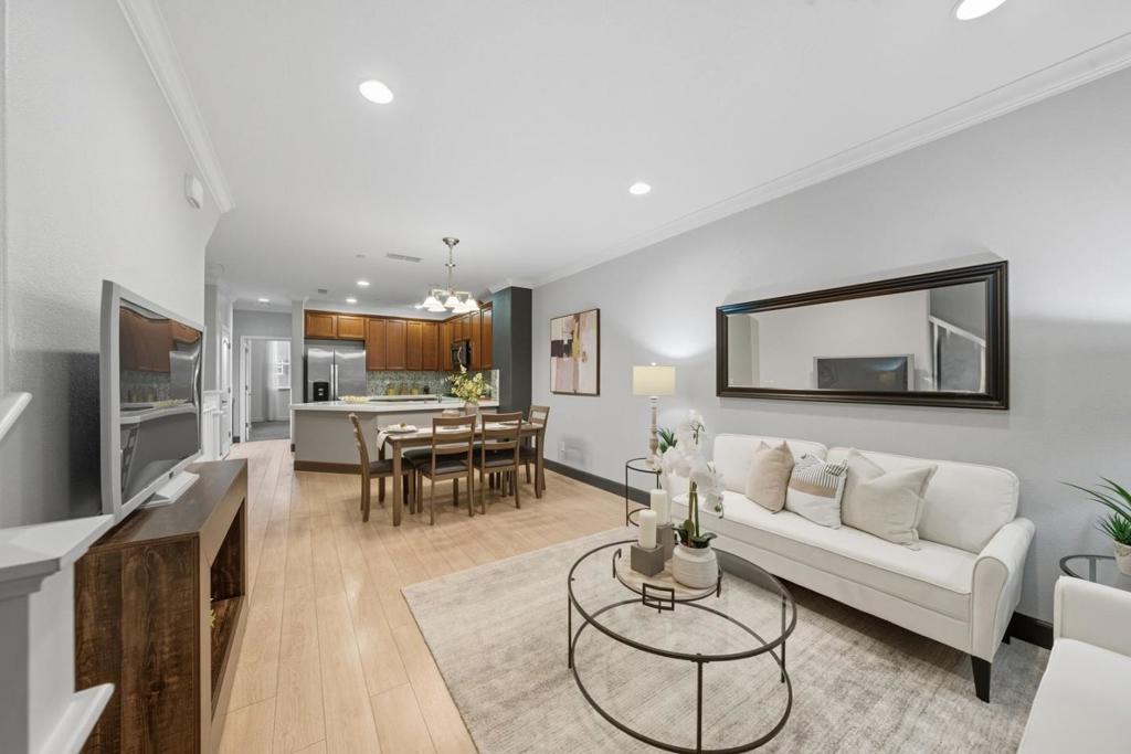 Charming townhouse style condo located just moments from the vibrant Santana Row and Westfield Valley Fair! This inviting home offers a stylish open floor plan with elegant laminate flooring throughout the main living areas. The kitchen serves as the heart of the home, featuring tile countertops, sleek cabinetry, matching laminate floors, and stainless steel appliances. A main-level bedroom and full bath make a perfect space for guests or a home office. Upstairs, the spacious primary suite provides a relaxing escape with dual sinks, a glass-enclosed shower, and a generous walk-in closet. You'll also find a junior suite with its own private bathroom and a convenient laundry room on the same level. Enjoy year-round comfort with central heating and air conditioning, along with a 2-car tandem garage. Ideally situated within walking distance to popular shops, restaurants, entertainment, gyms, and Frank M. Santana Park. Close to major employers like Apple and Nvidia, with quick access to highways 280, 880, and Caltrainmaking commuting effortless!