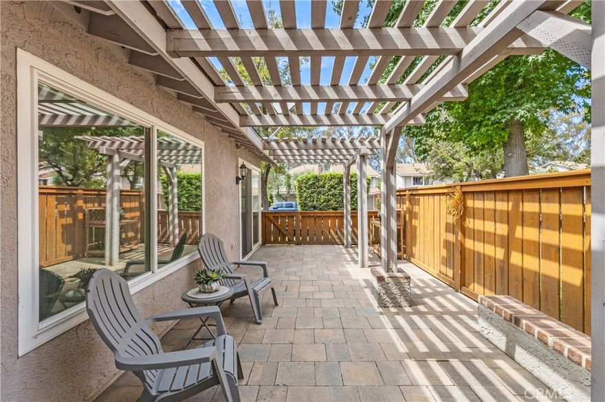 Welcome to this turnkey single-level townhome, ideally positioned on a prime corner lot in the highly desirable Parkview Community of Anaheim Hills. Offering 2 spacious bedrooms, 2 bathrooms, and 1,123 sq ft of living space, this gorgeous home combines comfort, style, and convenience. The gated entry welcomes you into a bright and open interior featuring high volume ceilings, expansive windows, and elegant tile flooring throughout. The open-concept layout seamlessly connects the living and dining areas, enhanced by recessed lighting, Dormer shutters, a cozy fireplace, and the privacy of only one shared wall. The beautifully remodeled kitchen features quartz countertops, stainless steel appliances, and generous cabinetry. The spacious primary suite overlooks a serene private patio and includes a large walk-in closet. The updated en-suite showcases a walk-in shower with bench seating, extended cabinetry, and sleek quartz countertop. Outside, the tranquil rear patio offers a peaceful escape, framed by mature landscaping and direct access to the community’s lush greenbelt—ideal for morning walks or evening relaxation. Residents enjoy access to a sparkling community pool and well-maintained grounds. Minutes from Anaheim Hills Golf Course, scenic nature trails, and local dining - this location offers the best of Anaheim Hills living. With quick access to the 91 Freeway and 241 Toll Road, commuting is a breeze. Plus, you’re in a top-rated school district. Don’t miss your chance to own this stunning corner-unit townhome!
