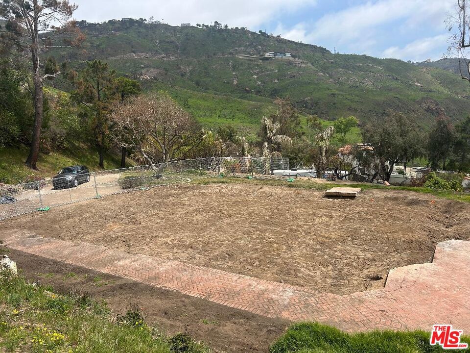 Amazing Fire Rebuild 1.3 Acre Lot in the Prestigious Sea View Estates community. Located only 5 minutes from PCH and ocean , this property has a large flat graded building site with beautiful views of the Malibu hills and ocean . Save hundreds of thousands of dollars with easy to obtain fire rebuild permit process an existing septic system, water meter , graded pad, driveway and more . Previous home was 3162 sq.ft per tax assessor records with four bedrooms and three bathrooms. The property offers tremendous investment opportunity with homes selling in area for over $3,000,000. Located minutes from Malibu's beaches, trailheads, the Malibu Country Mart and easy access to Valley too. By far the best priced Fire Rebuild lot on the East side of Malibu or Palisades!