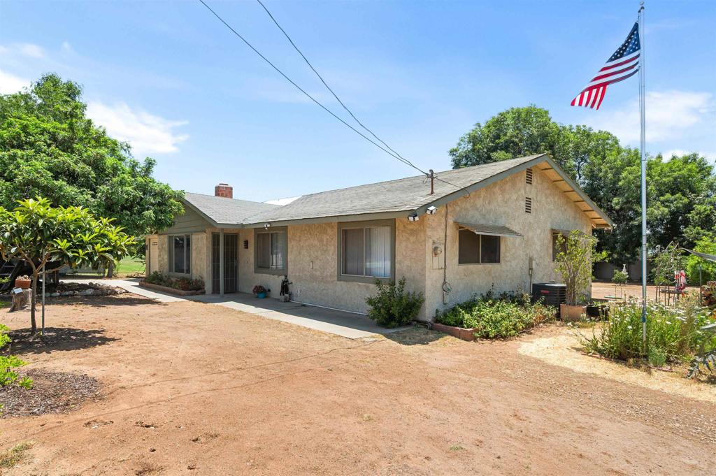 Dreaming of a tranquil haven to grow, build, and create something truly your own? Set in Riverside’s sought-after Woodcrest area, this single-story 3-bedroom, 2-bath home rests on just over half an acre of flat land! A classic brick fireplace sets the tone for intimate evenings in the living room, while the eat-in kitchen delivers timeless character with its tile countertops, ample cabinets, and essential appliances. Venture outside to find a covered patio made for weekend BBQs, leading to a garden surrounded by loquats, passion fruit vines, and trees bearing limes, figs, pomegranates, pineapple guava, and mulberry. Your sprawling backyard is ideal for adding a guest house, a pool, or even horse amenities. With an updated HVAC and septic system already in place, plus an attached 2-car garage, enjoy its functionality from the start. You’re mere minutes from local schools, everyday conveniences on Van Buren Blvd, and have easy access to the 91 Fwy, I-215, March ARB, and Lake Matthews. If you're ready to shape a future filled with possibility, this Riverside retreat could be the one to make it real!