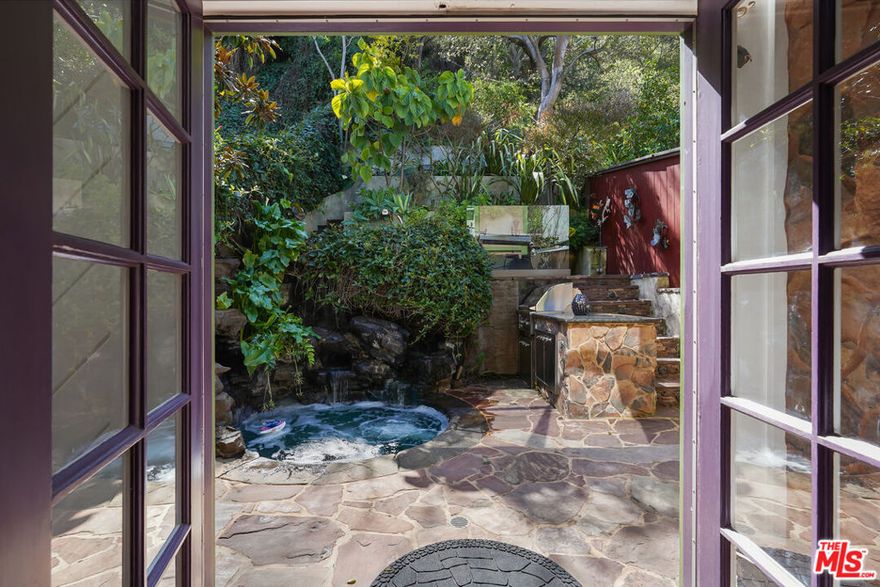 Welcome to a rare opportunity to lease an exceptional property nestled in the prestigious Beverly Glen Canyon of Bel Air. Just 2 miles north of Sunset Boulevard, this architectural gem harmoniously blends sophistication with style, offering an idyllic retreat in one of Los Angeles' most sought-after neighborhoods. This thoughtfully designed home boasts wood and custom carpeted floors throughout, highlighting the spacious and airy feel of the living spaces. The gourmet kitchen is equipped with sleek granite countertops and stainless-steel appliances, perfect for both cooking and entertaining. The expansive living room features soaring two-story ceilings, allowing for an abundance of natural light, while the oversized fireplace adds warmth and charm to the space. Upstairs, the romantic master suite is a serene sanctuary, complete with skylights that bathe the room in soft, natural light. A generously sized second bedroom offers ample space for guests or family members. For those who appreciate an active lifestyle, the lower level provides a versatile office/gym area, ideal for work or workout. The outdoor oasis is equally impressive, featuring a custom grotto hot tub with a tranquil waterfall, a built-in outdoor barbecue, and an inviting seating area  perfect for entertaining or relaxing in complete privacy. Located just minutes from Beverly Hills, UCLA, and all the best the Westside has to offer, this property is also a stone's throw from the Glen Centre, offering convenient access to shops, restaurants, and more.