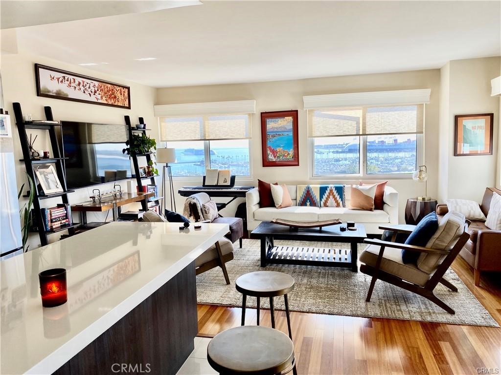 Stunning and spectacular views to be enjoyed here for all seasons, day or night. This remodeled 2 bedroom, 2 bath condo is located in the highly desireable Harbor Place Tower on the 12th floor. At just over 1,300 square feet this warm and comfortable home is newly remodeled with fresh paint, warm wood flooring throughout, a kitchen with custom cabinetry including all the modern appliances: Oven/range, refrigerator, dishwasher, and built-in Microwave. Custom lighting fixtures finish off the beautiful interior. Two balconies off the main living area and bedroom provide the perfect perspective while viewing the fabulous City of Long Beach that include panoramic views overlooking the Pacific Ocean, San Bernadino Mountains and the sparkling city lights. Bathrooms each feature walk-in showers, modern cabinetry, sinks and faucets. Two parking spaces are assigned to the unit in the gated community garage. Located blocks away from all the exciting venues in Downtown Long Beach, Harbor Place Tower is a beautiful building with a 24-hour security guard on duty, a package concierge, a pool with sun deck and spa, a large fitness center, men's and women's saunas, community room, viewing deck and 80 guest parking spaces.
