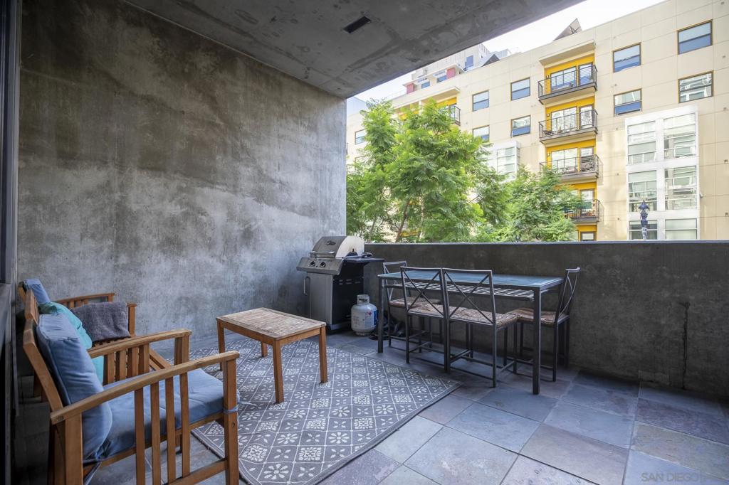 This modern 1-bedroom, 1-bath loft in the desirable Fahrenheit building offers high ceilings, exposed concrete walls, and oversized windows that fill the space with natural light and industrial character. The open floor plan features a contemporary kitchen with stainless steel appliances and a large island flowing into the living and dining areas—perfect for entertaining. The bedroom provides modest separation while maintaining the loft’s open feel, and the bathroom is clean and modern. In-unit full-size washer and dryer add convenience, and a private balcony offers a quiet outdoor retreat. The unit includes one assigned parking space and is just steps from Petco Park, the Gaslamp Quarter, and top restaurants and cafes, making it ideal for urban living.