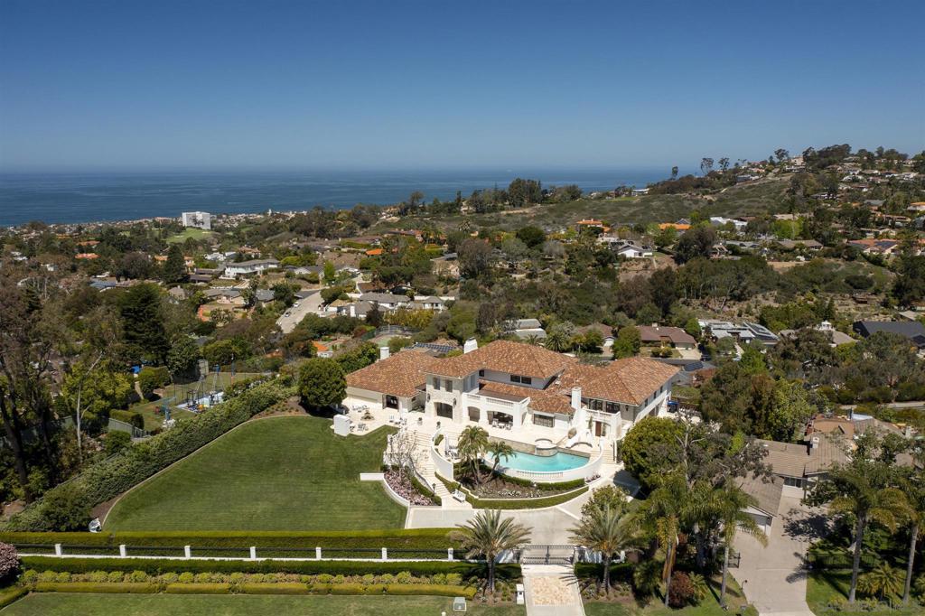 Celebrating and savoring panoramic sea, sunset and hillside views from its unique mountainside perspective, this magnificent, updated gated estate property offers lavish comfort on an exceptionally beautiful site. Classic architecture has been appointed with modern design elements for sophisticated elegance throughout, and spectacular grounds of just under an acre include expansive lawns, patio, pool, spa and fireplace for entertaining on a grand scale. One level living offers a sleek SieMatic kitchen and secondary suites upstairs as well as a massive recreation room with sweeping ocean, hillside and sunset views. Magnificent modern updates include a top-of-the-line Siematic kitchen with steam oven. Enjoy indoor/outdoor living with four fireplaces inside, (including the vast upstairs recreation/game room,) and inviting fireplace seating in the private backyard. Welcome guests with plenty of parking within the gates and numerous areas for grand or intimate gatherings. A very special private estate in a picturesque, easy-access setting. Equipment: Range/Oven Sewer: Sewer Connected Topography: LL,GSL