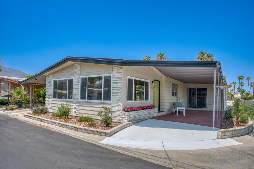 Turn-key 2 bed, 2 bath, 1,740 sqft manufactured home located in the desirable El Dorado Palms Estates, 55+, gated community! The interior is open and spacious with vaulted ceilings, and recessed lights. Enter in the living room which flows into the updated kitchen with center island, stainless steel appliances, and white cabinetry. The huge family room sits on the other side of the kitchen as well as the 2 bedrooms, each generously sized with the primary suite offering a spa-like ensuite with dual vanities, a soaking tub, and a shower. The laundry room and a full-size bathroom complete the floor plan. Enjoy the covered patio as well as tandem 2-car carport parking. Residents also get to enjoy an array of amenities including pools, spa, club house, library, card room, rec room, and many community events. No land lease, you own the land. Schedule your private tour today!