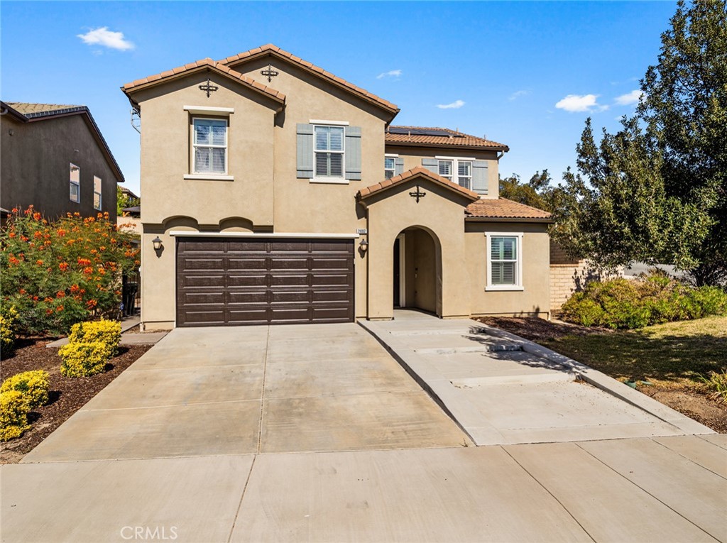 Large Spanish-style home in trendy Plum Canyon area. This two-story single family residence is situated on a large corner lot in a handsome neighborhood with views of the surrounding mountains. The sophisticated interior displays clean lines, natural colors, and details like high-gloss tile floors, recessed lighting, modern wall tiles, and crown moldings. The lower level’s open floor plan includes a large, modern kitchen with stainless steel appliances, a kitchen island, a walk-in pantry, and ample space for informal dining. The living room is open to the kitchen on one side, and a wall with a pass-through window keeps it separate, but open to the adjacent formal dining room. There is also a laundry room, a carpeted secondary bedroom, and a full bath on the main floor. Upstairs, in addition to the remaining four bedrooms, there is a large loft with wood laminate floors that may be used as a family room. The primary suite also has laminate flooring, as well as double doors, a walk-in custom closet, and a private full bath with dual sink vanities and a separate shower and soaking tub. The three secondary upstairs bedrooms feature carpeting and plantation shutters. One of these bedrooms has its own private full bath, while there is a full bath in the hallway for the other two. Out back, find a large yard with a patio, a basketball hoop, and tall palms. This home’s size, design, and excellent condition, along with its prime location near schools, shopping, and parks, make it a must-see! Solar is paid off as well.