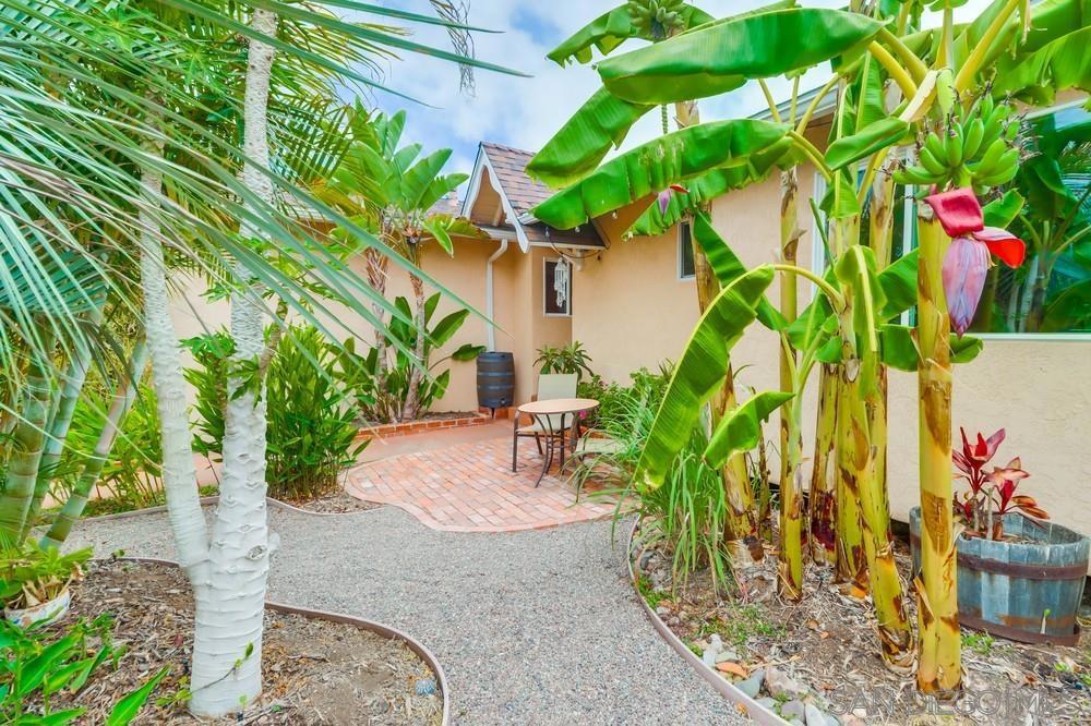 Hidden Serra Mesa gem! Find serenity & feel the open space in this exquisite luxurious home, beautifully & meticulously maintained w/ a Boho feel. The interior is bright with ample natural light, streaming from a bathroom skylight & solar tubes. Home features dual pane windows w/ lifetime warranty, original oak hardwood floors & home audio throughout. The chef's kitchen features new Calcutta Gold Quartz counters, custom wood cabinets, premium 6 burner stove, oversized sink. (continued in supplement) Front en suite bedroom overlooks the tropical front yard, rear bedroom has custom closet storage & steps out into the private patio & garden. Don't miss the full wall tropical mural by a local artist in the sunken grand family room, complete with home theater surround system. Spacious 2 car garage has epoxy floor, custom cabinets, updated electrical & ample overhead storage. The yards have a serene oasis feel: find a walking path in the front winding through avocado, pomegranate, banana, olives, papaya, orange & surinam cherry trees; overlooking the canyon in the backyard you'll find a covered private Lanai, a Brazilian Quartzite BBQ w/ wet bar, rotisserie, sear burner, 6 burners, warming drawer. Located in charming Serra Mesa, this home is peaceful & tranquil while being centrally located & within minutes of shopping, eateries & culture.