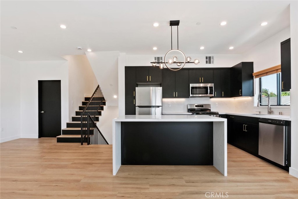 Modern luxury meets prime location! Welcome to this stunning townhouse style unit which is 3 stories with a rooftop deck. It has 3 bedrooms and 3.5 bathrooms, and your own 1 car garage with direct garage access for convenience. This building is gated and secure. This unit is brand new, and never lived in. This unit offers large windows with enormous amount of natural light. Enjoy 1616 sq ft of refined space, ideally situated at the crossroads of West Adams, Culver City, Santa Monica, Century City, and Beverly Hills. Additionally, the property has a high walk score, and is close to everything.
Enjoy a custom-designed kitchen with an island, featuring quartz countertops, and abundant cabinet space, and a spacious center island perfect for cooking, dining, or entertaining. Outfitted with stainless steel appliances, this kitchen is as functional and beautiful. The kitchen even has its own balcony.
The 3 bedrooms are spacious and have lots of natural light, and are already wired for TV and cable internet.
The roof top deck has beautiful views, sink, shade sail, and hook up for your BBQ.
This unit also includes an eco-friendly tankless water heater, central HVAC, in-unit washer & dryer, and solar panels to help you save on electricity. The garage offers electrical charger for your electrical vehicles.