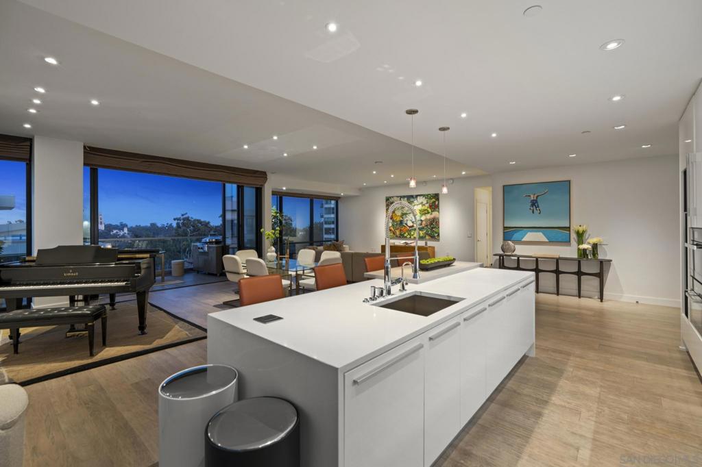 Some residences are built to impress. Residence 801 was created to inspire. Located on the Northeast corner of the 8th floor of Bankers Hill’s most distinctive boutique address, 41West, this residence opens wide beneath 10-foot ceilings and retracting NanaWalls that frame San Diego’s most celebrated views: Balboa Park’s California Tower, the buzz of Bankers Hill and even a sliver of the Pacific from your private corner terrace. The arrival is dramatic, double doors open into a living space grand enough for a grand piano, with morning light streams across the room. Every detail elevates daily life: Vantage-controlled lighting that sets the mood with a single touch, automatic shades that vanish into silence, and a concealed 110-inch screen that transforms the room into a private cinema. The “music room” speaks to the current owner’s love of vinyl, yet its flexibility invites reinvention, a library, study, or hidden pantry. The kitchen is a dream, outfitted with Miele appliances (steam oven, five-burner gas cooktop, built-in wine cabinet), Italian cabinetry, and filtered water. Retreat to the primary suite, where park views, a spa-inspired bath with soaking tub and oversized shower, and a custom walk-in closet redefine comfort. A second bedroom is equally impressive and offers its own park-framed views. *See Supplement for More Details* Only four homes share this floor, and just 41 in the building, true boutique living. The lobby makes a statement, the hallways a gallery, and there is true magic outside with the cultural heartbeat of Balboa Park, Bankers Hill’s dining and café scene, and a neighborhood steeped in history yet alive with energy. 2 side by side parking spaces, storage unit and EV charging station. Residence 801 at 41West — as rare as it is refined. MARKETING VIDEO IN VIRTUAL LINK!