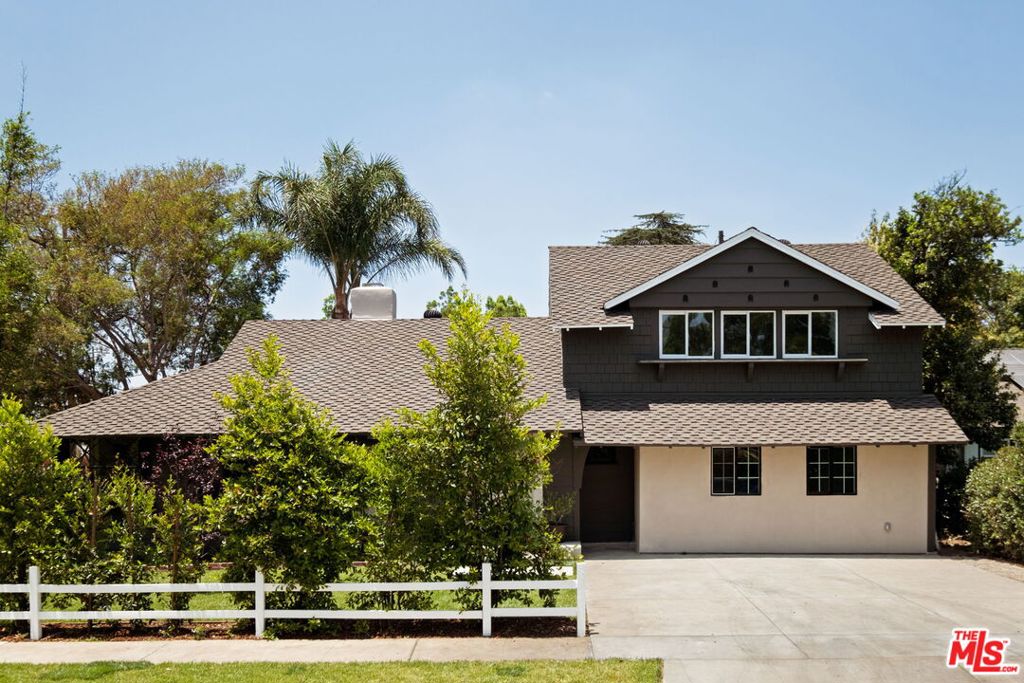 Welcome to this exquisite, fully renovated mid-century home, nestled in the heart of the valley. From the moment you arrive, you'll be captivated by the home's timeless elegance and stylish design. Featuring four generous bedrooms and three meticulously upgraded bathrooms, this property sits on an expansive lot complete with a large pool and a spacious backyard perfect for summer events with friends and family. Inside the living room you are welcomed by abundant natural light, high exposed beam ceilings, and a striking fireplace that creates a warm and welcoming atmosphere. The adjacent dining area features diamond lattice windows that add a touch of charm and character. At the heart of the home lies a spacious chef's kitchen designed for both function and style. It boasts elegant marble countertops, custom cabinetry, a convenient breakfast bar, a premium Viking stove, and a beautifully integrated Dacor built-in refrigerator. French doors lead directly from the kitchen to the stunning backyard and pool. Down the hall, you'll find a guest bedroom and a luxurious primary suite. The primary offers a generous bedroom area, a massive walk-in closet, and a spa-like ensuite bathroom complete with double sinks, a large walk-in shower, and sleek porcelain countertops atop custom cabinetry. Upstairs you'll find two more bedrooms and a large bathroom thoughtfully laid out so the kids have a quiet place to relax while the adults continue outside near the pool on long summer nights. The expansive backyard boasts a spacious pool, ample room for entertaining, mature trees and ficus hedges for added privacy, and two towering palm trees that capture the quintessential California style. This property provides easy access to Sherman Oaks, Burbank, Encino, Studio City and more. It's just 10 minutes from the Sherman Oaks Whole Foods and Ventura Blvd. It is a special, quiet retreat that captures the very best of life in the San Fernando Valley.