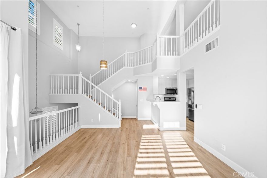 Step into this stunning end-unit tri-level home in the coveted Chambray community of Ladera Ranch—where soaring two-story ceilings, abundant natural light, and a beautifully upgraded interior come together to create the perfect place to call home.

This bright and open 2-bedroom, 2-bath floor plan lives large, enhanced by new laminate wood flooring throughout and an inviting main level that feels both spacious and warm. The kitchen features crisp white cabinetry, quartz countertops, stainless steel appliances, and recessed lighting, flowing seamlessly into the living and dining areas. Enjoy indoor-outdoor living on your private front patio—ideal for relaxing or entertaining. where you can unwind with sweeping neighborhood views, including sparkling evening lights and tranquil mountain backdrops.

The generous primary suite offers a walk-in closet and a refreshed en-suite bath with dual sinks. The secondary bedroom is equally spacious and served by a full hall bath. Upstairs, the impressive loft provides endless possibilities—use it as a bonus room, office, or easily convert it into a third bedroom. Convenience is key with an in-unit washer/dryer, an attached 1-car garage, and an additional assigned parking space.

Living in Ladera Ranch means enjoying unmatched resort-style amenities—high-speed internet, pools, splash parks, clubhouses, sports courts, hiking and biking trails, a dog park, community gardens, and more. All within walking distance to Bridgepark Plaza with Albertsons Market, shops, and restaurants. 

This exceptional end-unit home offers style, comfort, and the best of Ladera Ranch living—don’t miss it!