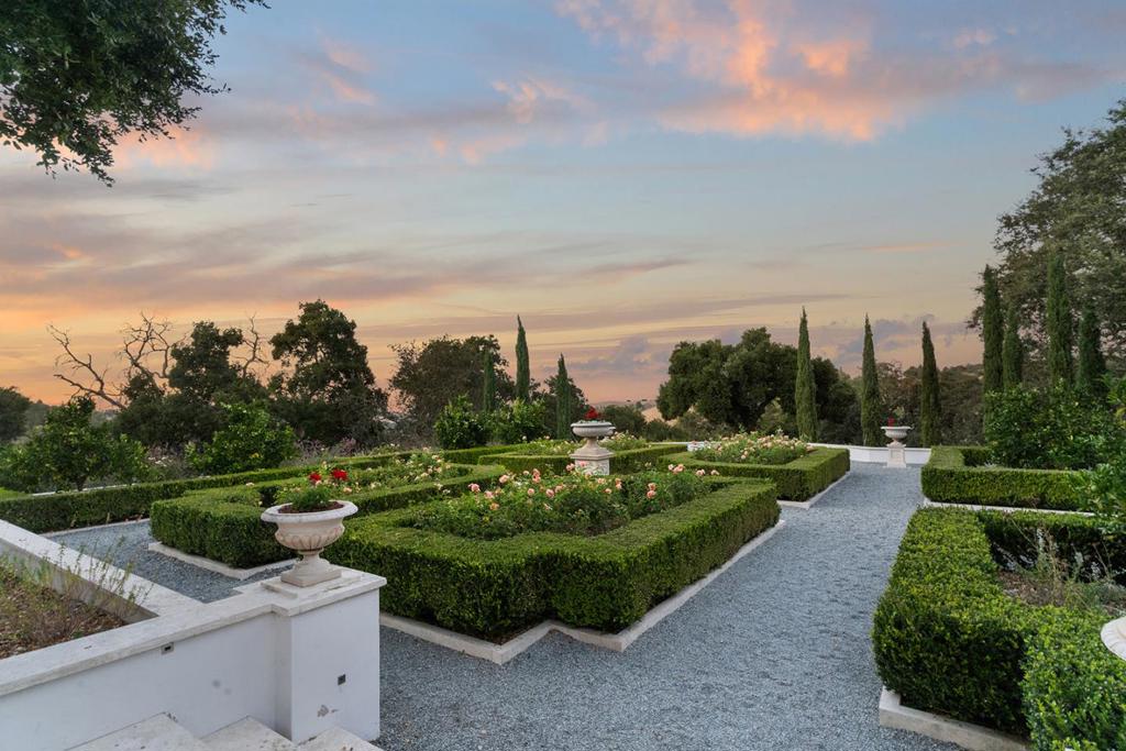 Discover a Mediterranean retreat where luxury and nature blend effortlessly. Nestled on 2.68 acres of gated privacy, approx 6,241 living sqft, 5 beds plus office, 6 bath, English rose garden with outdoor kitchen on western hill view. Step inside to an oasis of refinement, with gleaming hardwood floors, airy white interiors, and expansive terraces offering serene views of the landscape. Whether you're hosting a lively gathering in the lower-level recreation room and wine cellar or dining al fresco in the heated outdoor kitchen and lounge, this home is made for unforgettable moments. On the main level, sunlight pours into spacious, open areas, including a chefs gourmet kitchen, grand formal living rooms, and a private office adjacent to the opulent primary suite. The lower level features four additional bedrooms, two with their own en suite baths, ensuring comfort and versatility for any lifestyle. With its timeless sophistication, exclusive privacy, and close proximity to world-class amenities and top-rated Palo Alto schools, this estate is the ultimate Silicon Valley sanctuary. Indulge in a life of beauty, comfort, and luxury at this extraordinary Mediterranean haven.