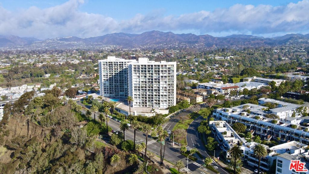 Incredible value for remodeled 2 bedroom on Ocean Avenue. This designer-done unit with views of palm trees, greenery and gorgeous hills is completely updated with beautiful warm finishes. Gorgeous wide-plank wood flooring runs throughout the unit from the spacious living room to the open dining room, all with walls of glass. Additional outdoor dining on the peaceful balcony embraces indoor/outdoor living. Gorgeous custom kitchen with rich wood cabinetry, Bosch appliances, stone countertops, stainless steel farmhouse style sink and open shelving. The primary bedroom enjoys verdant views, a large closet and a stunning en-suite primary bathroom with Calacatta marble finishes throughout. The second bedroom also enjoys floor to ceiling glass with greenery views while the second bathroom has Calacatta and Carrara marble finishes and a chandelier adding to the luxurious ambiance. The building is best-in-class, with full amenities, Valet, Doormen and 24-hour Concierge, luxurious Fitness Center and ocean view Pool and Spa. The ideal Santa Monica location on Ocean Avenue, close to the most desirable beaches, hiking, biking trails, entertainment, shopping and restaurants in all of Southern California. The designer furniture also available separately for purchase.