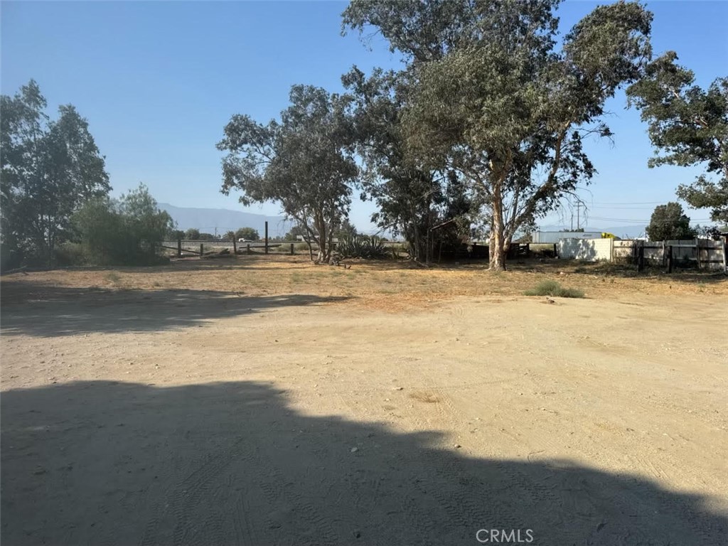 Only the back lot is for rent and accessible through a back road. The back lot 14700 SF ( 140 SF W and 105 SF L ) is for rent for open storage or other commercial uses. The landlord will build to suit the similar to the neighbor on the western side of the property, which is gated and has open storage. The landlord is willing to (1) remove the all trees/stumps (2) add fence with a gate; (3) Level all the dirt (4) put asphalt slags on the finished lot.
The back lot size is 140 SF width X 105 SF Length for a total 14700 SF flat lot for rent. This is a large lot with 2 buildings with residential tenants at front area.
Zoning Freeway Commercial and Industrial including open air storage
Ideal for open storage, semi-tractor trailer storage, parking, overflow storage, equipment lay down and other industrial/commercial storage needs
Features and advantages:
Strategic location overlooking the freeway and adjacent to a freeway exit (Cherry Avenue), situated in the heart of the Inland Empire's logistics hub with excellent access to major freeways 10 and 15.
Secure and Accessible: Mention if the lot is gated, secure, paved.
Flexible lease terms:
This is a rare opportunity to lease a well-located lot for your operational needs in a high-demand area
